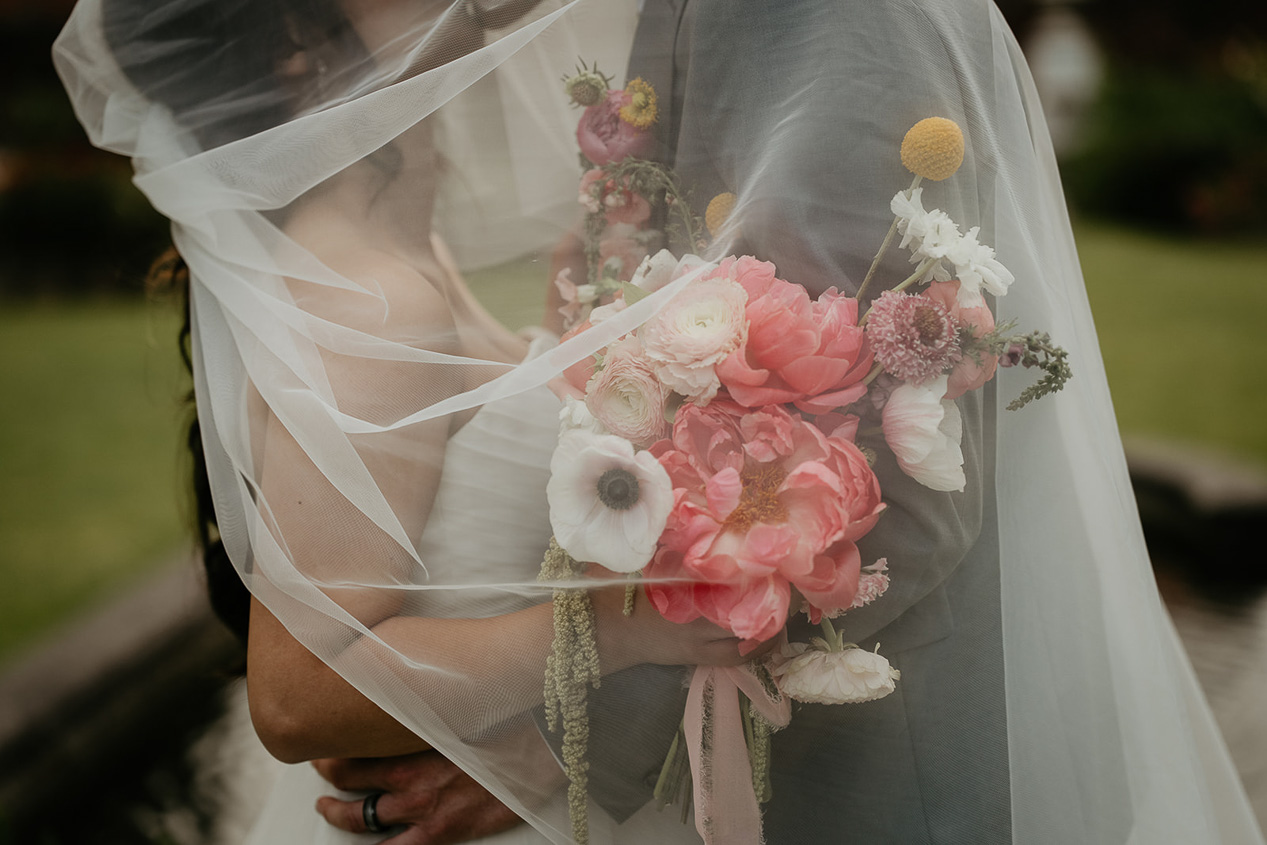 newlyweds under the bride's veil.