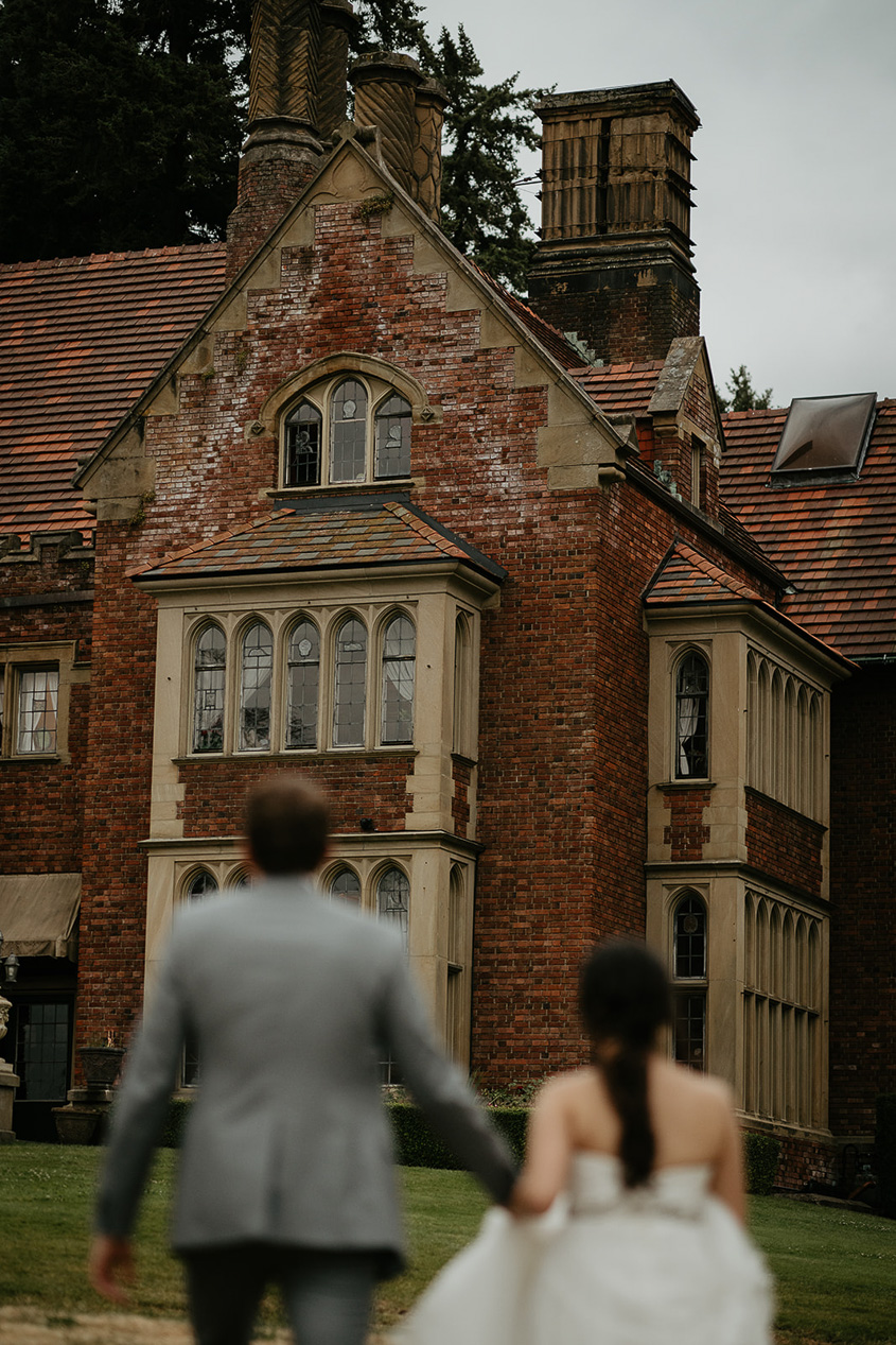 newlyweds looking at the thornewood castle wedding venue. 