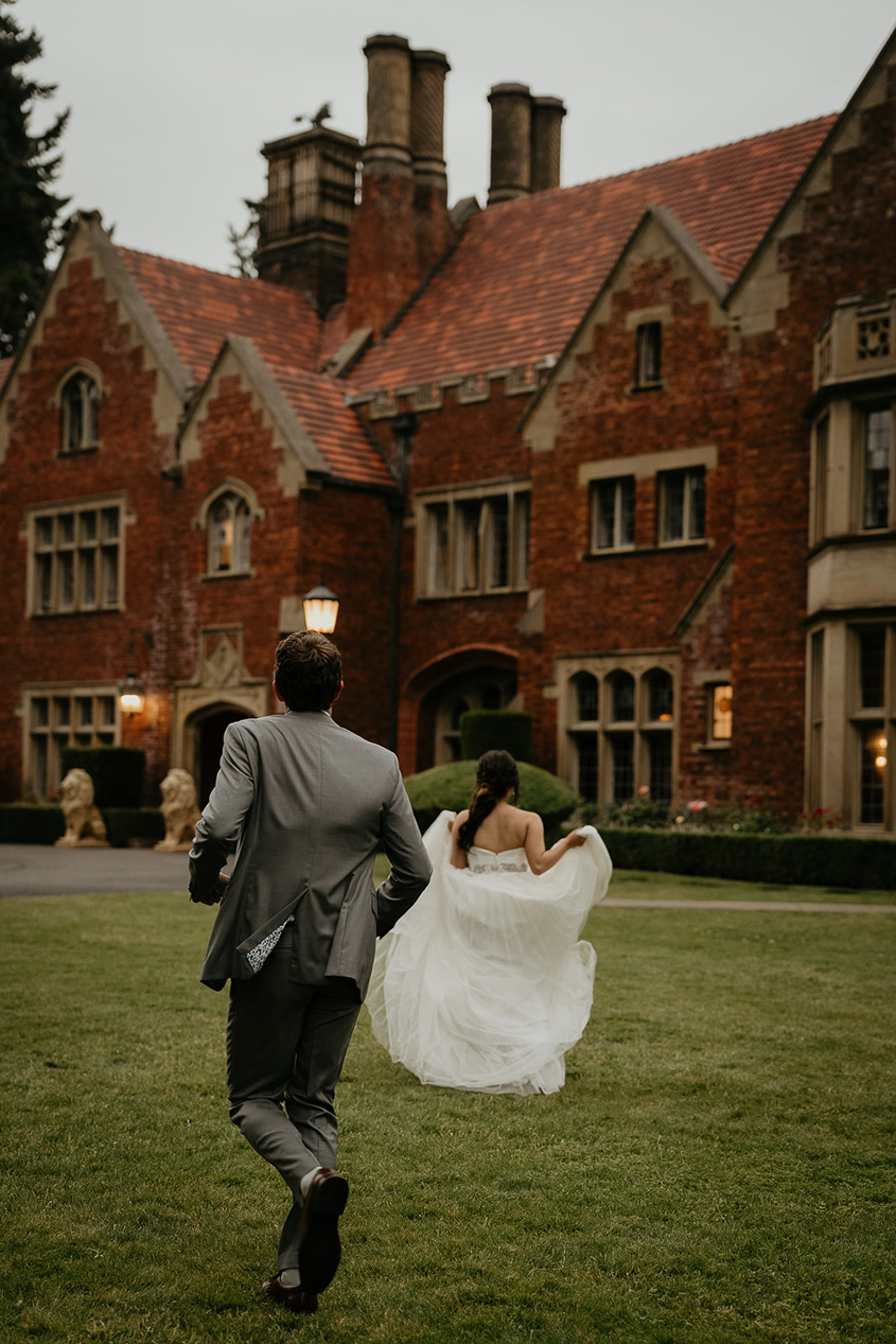 newlyweds running toward their thornewood castle wedding venue.