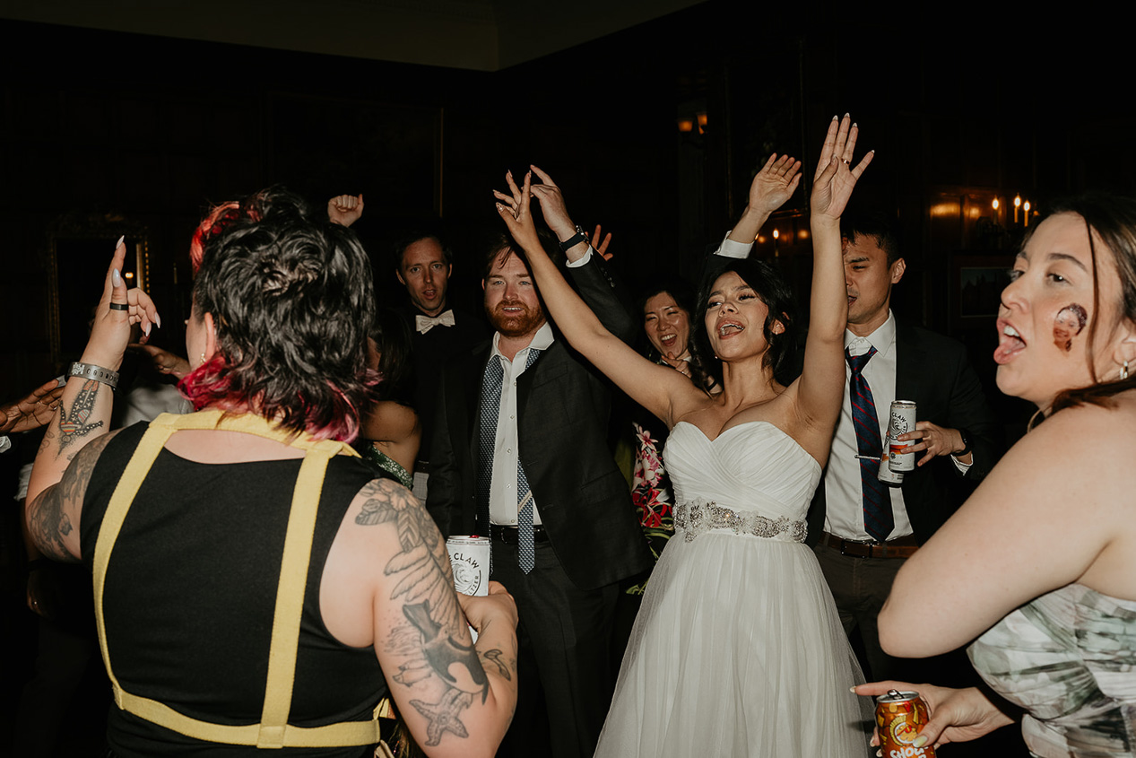 newlyweds and their wedding guests dancing during their thornewood castle wedding.