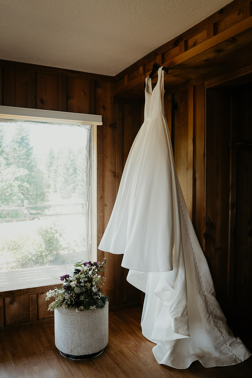 a dress hanging from a wooden door frame.