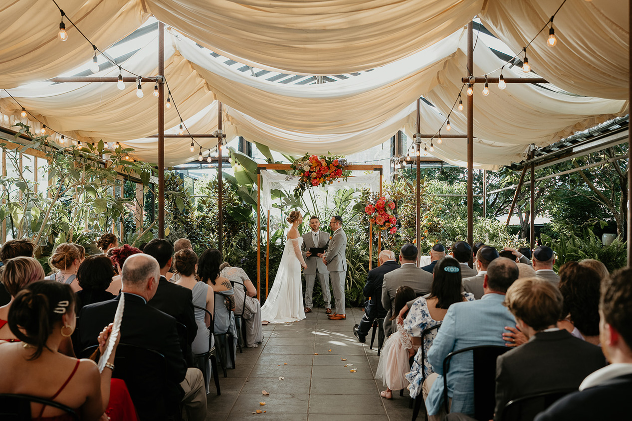 newlyweds during their wedding ceremony at Blockhouse PDX, one of the best wedding venues in Portland. 