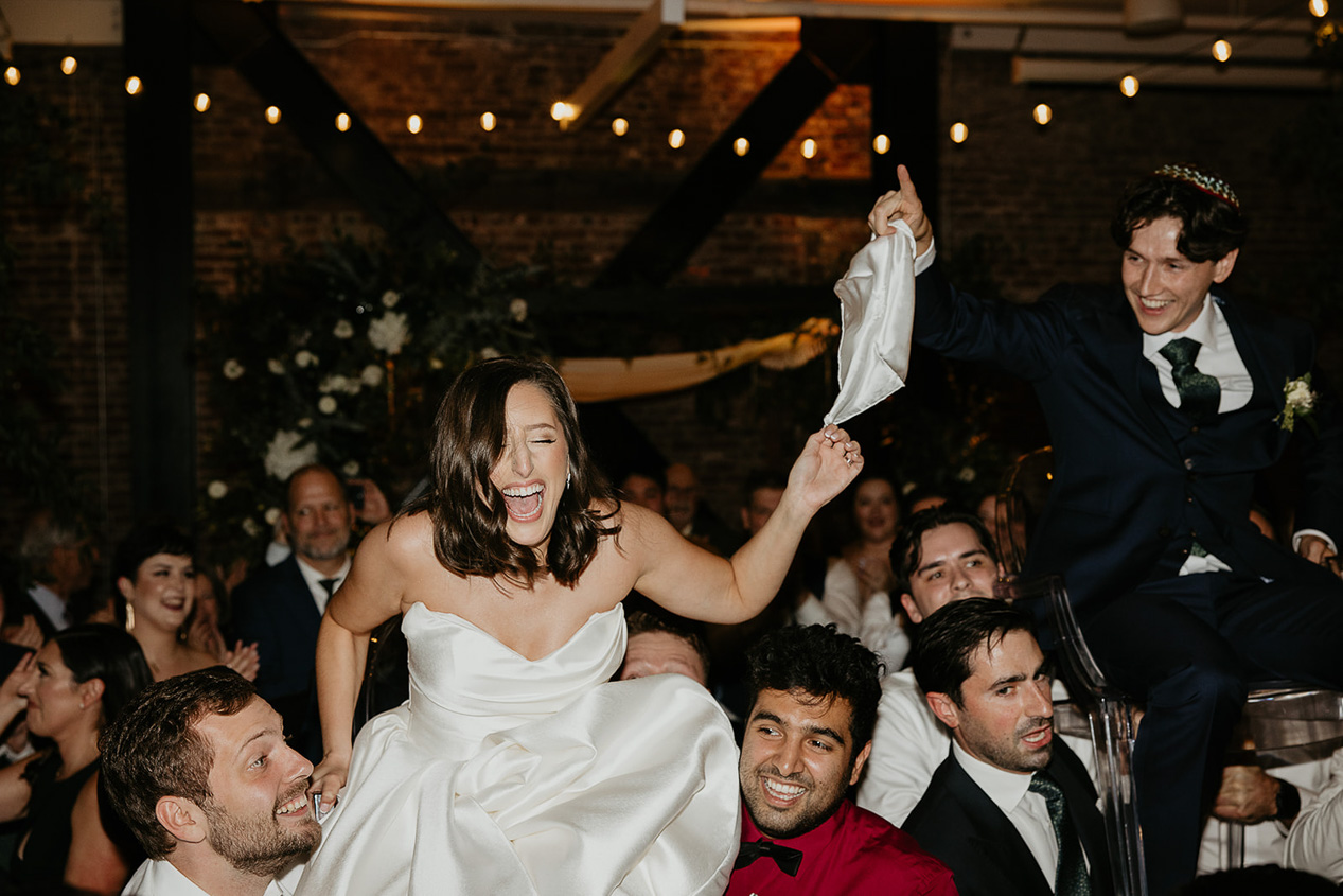 newlyweds partying during their wedding at the EcoTrust building, one of the best wedding venues in Portland. 