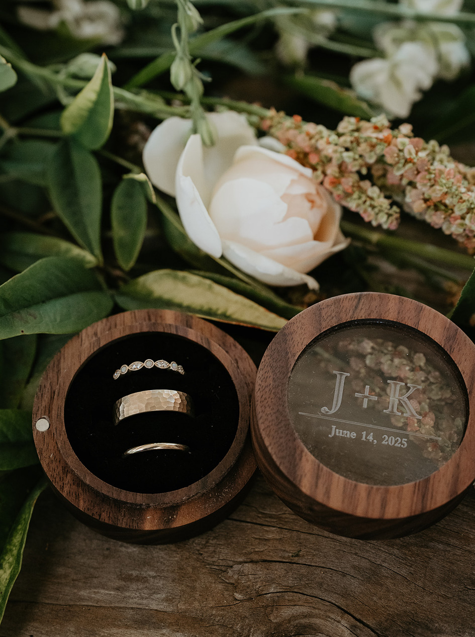 wedding rings, flowers, and a white rose.