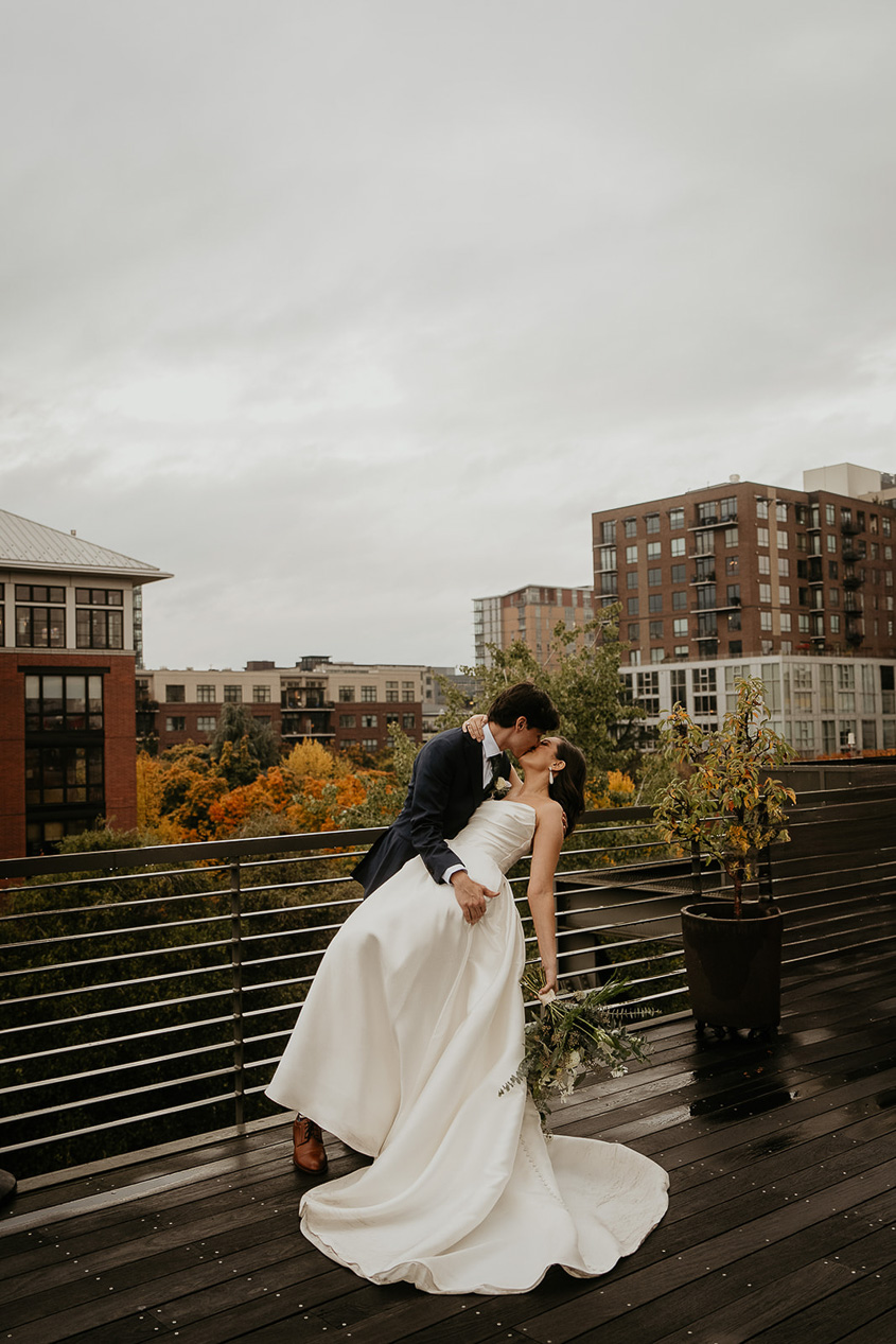 a couple kissing on top of the EcoTrust Building, one of the best wedding venues in Portland.
