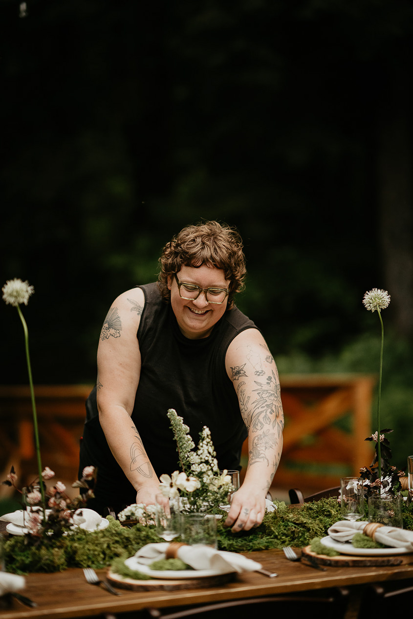 a florist arranging flowers at the Highland Farms wedding venue.