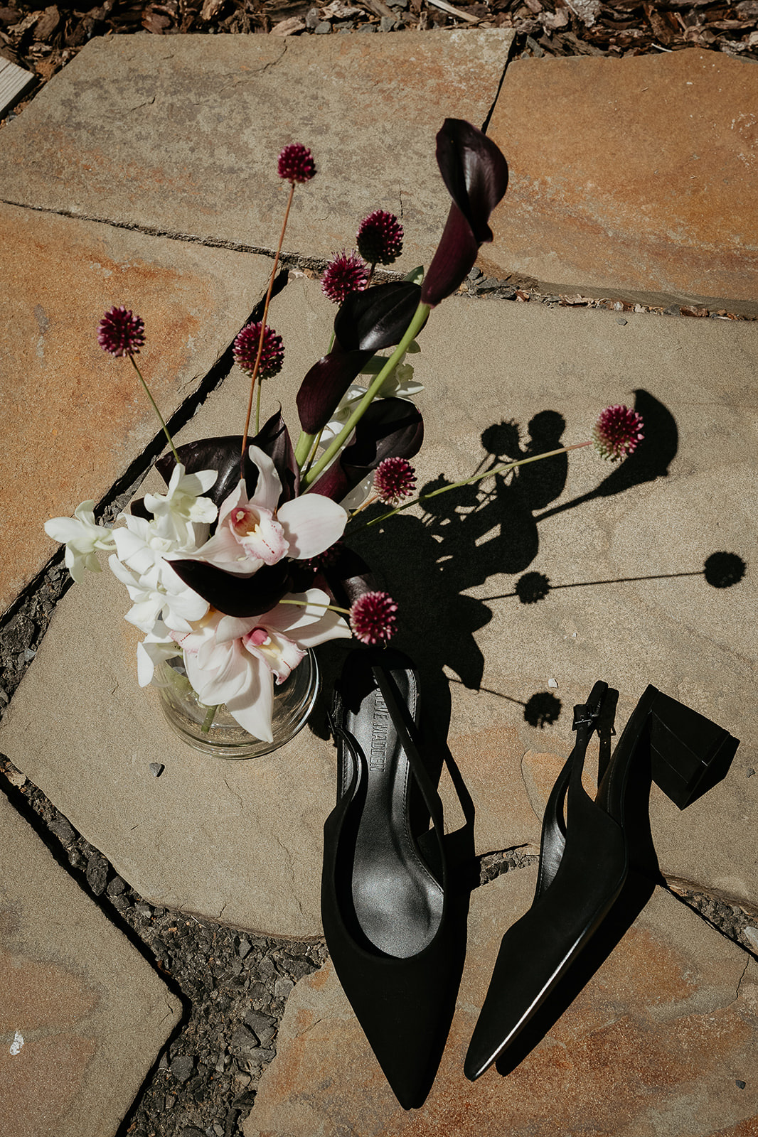 flowers and shoes on a stone ground, details to consider when you plan a micro wedding.