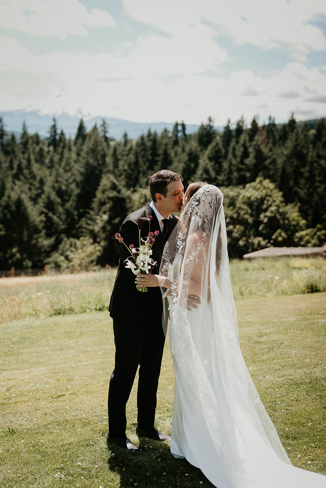 newlyweds kissing on a field, which they included as part of their plan for their micro wedding.