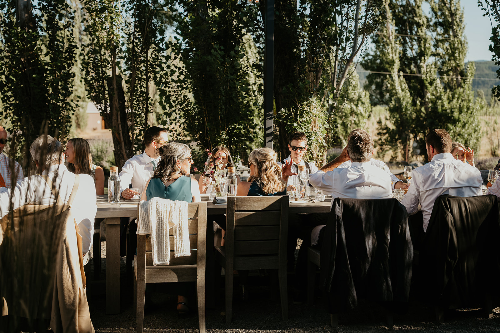 newlyweds at a table with their friends and family, which they included as part of their plan for their micro wedding.