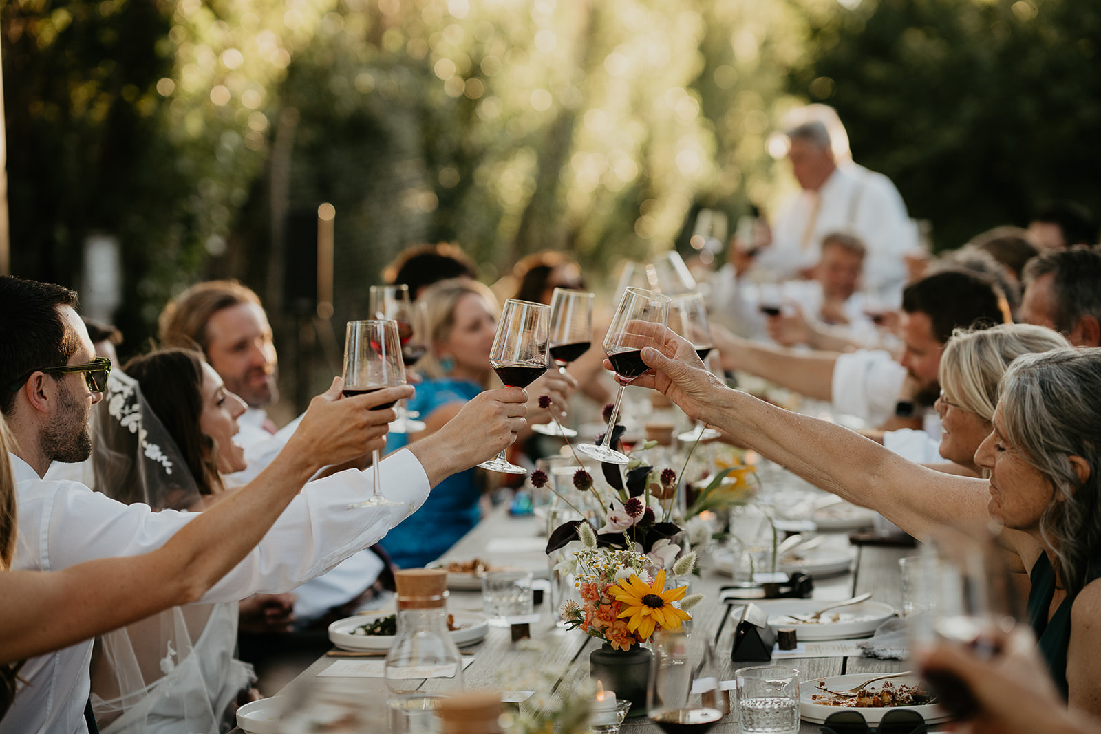 newlyweds cheersing with their friends and family, which they included as part of their plan for their micro wedding.