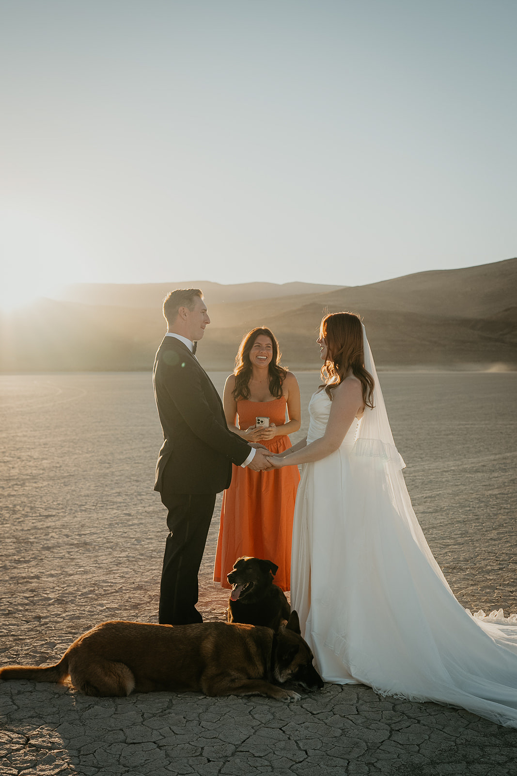 newlyweds holding their wedding ceremony in the desert during their Alvord Desert, Oregon elopement.