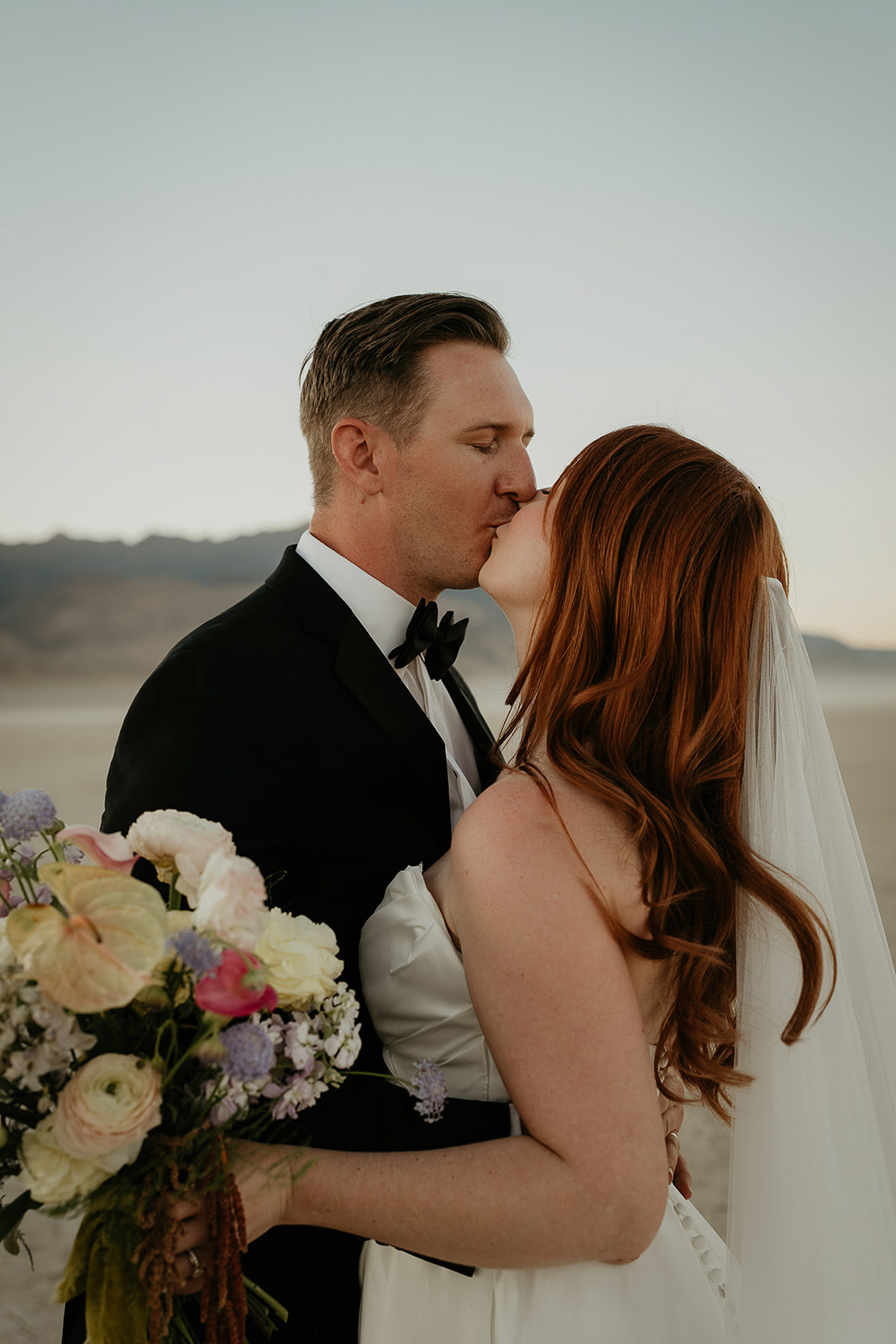 newlyweds kissing at sunset during their Alvord Desert, Oregon elopement.