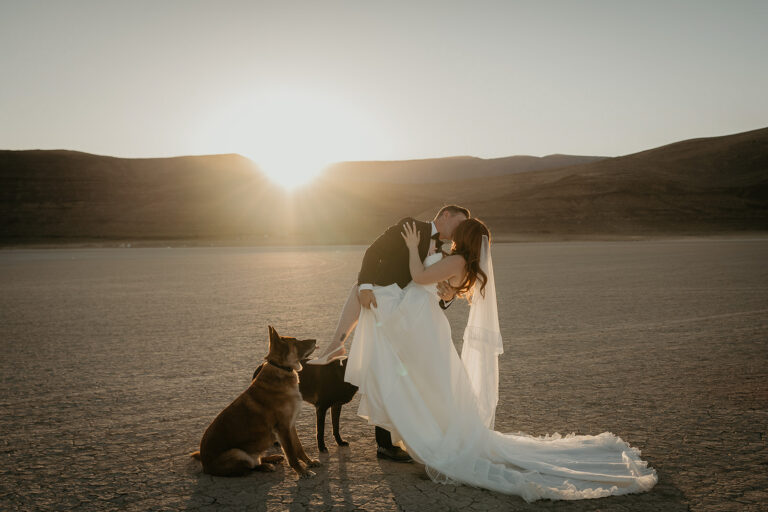 Newlyweds kissing on a desert playa during their Alvord Desert, Oregon elopement.