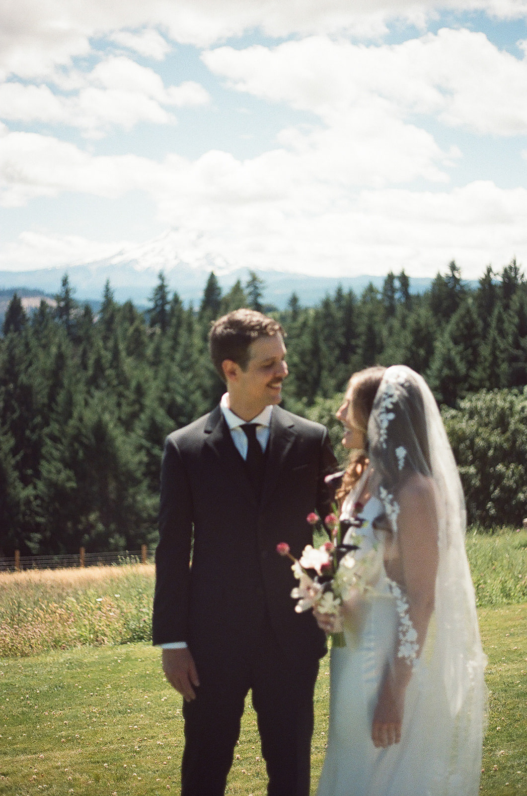 newlyweds smiling as they enjoy each other's company in the Columbia River Gorge.