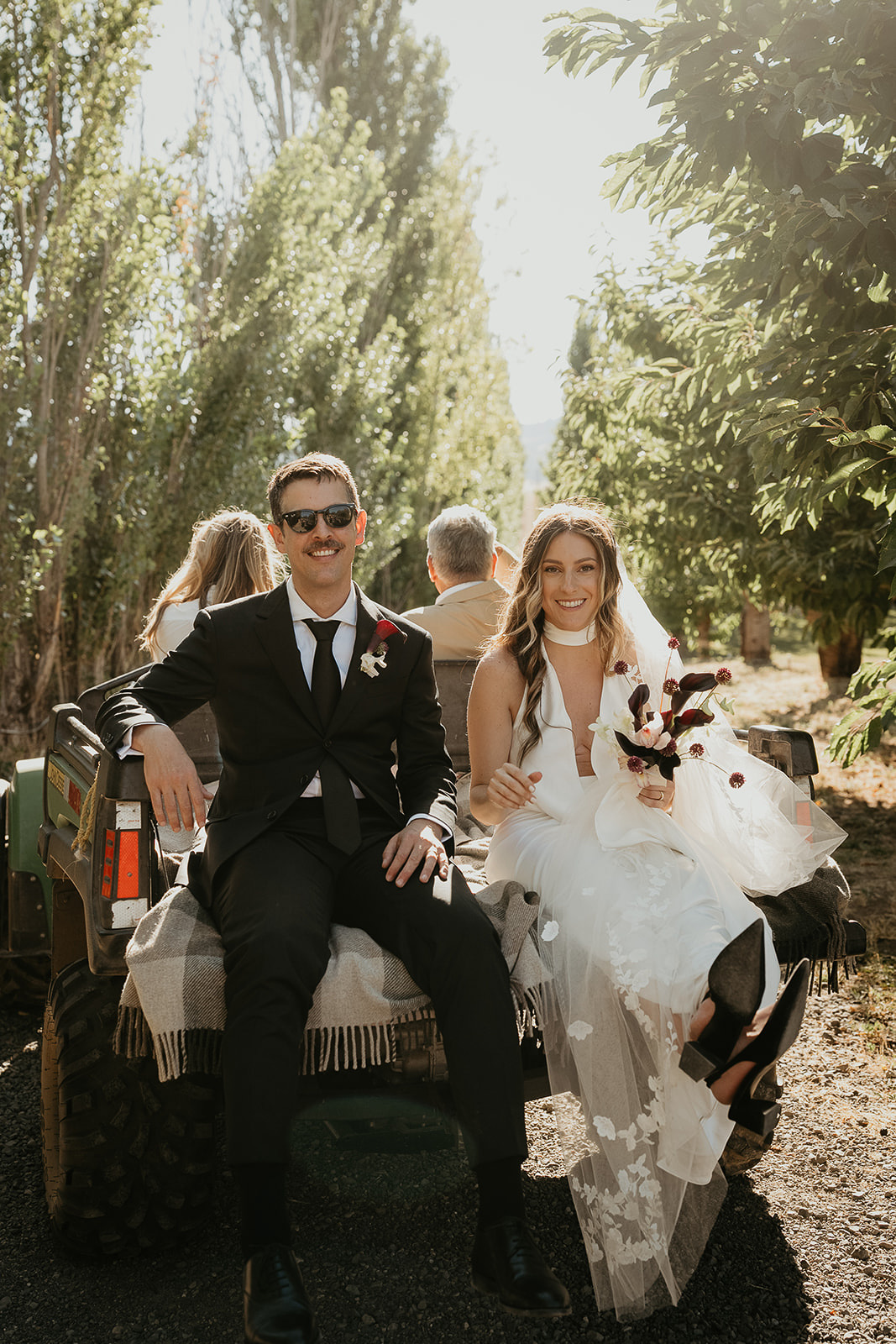 newlyweds enjoying a ride in the back of a truck.