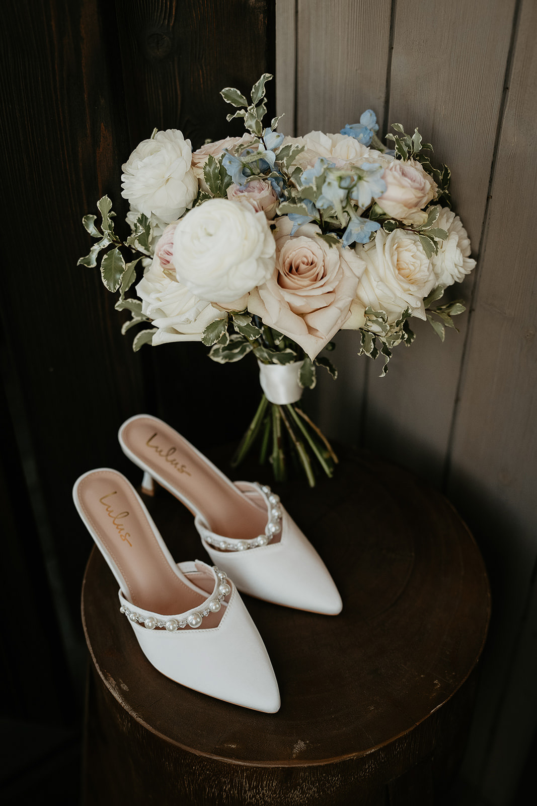 heels next to a flower on a table during a Brasada Ranch wedding.