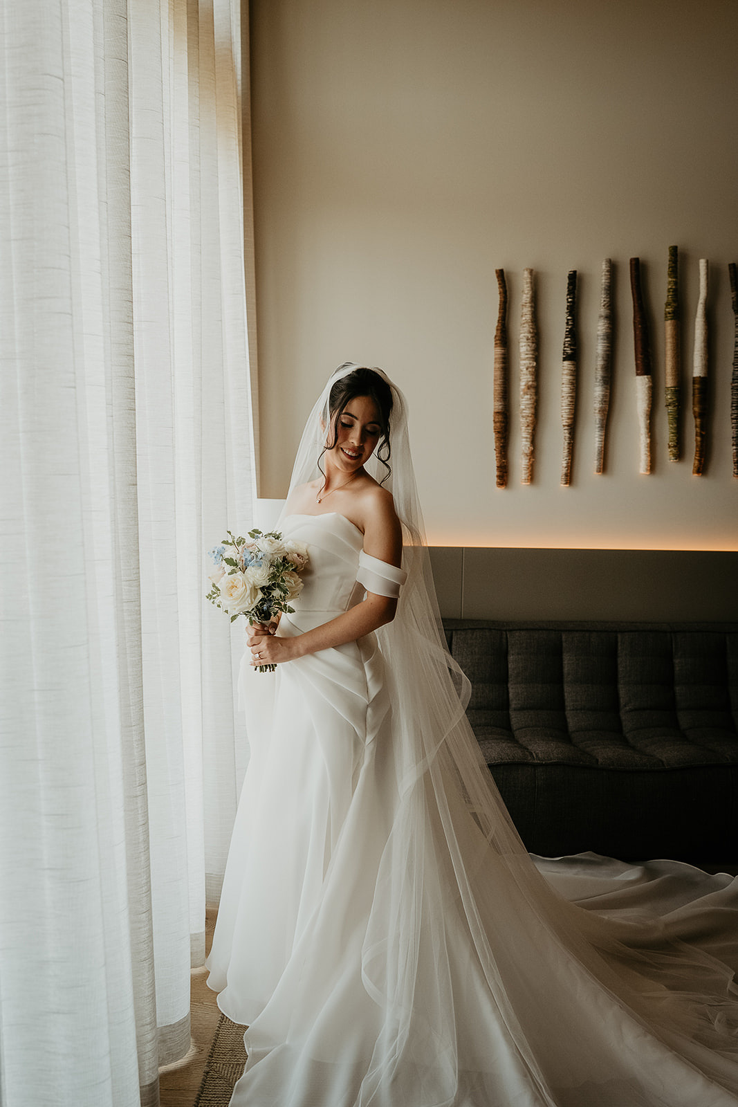 the bride in her dress holding a bouquet of flowers.
