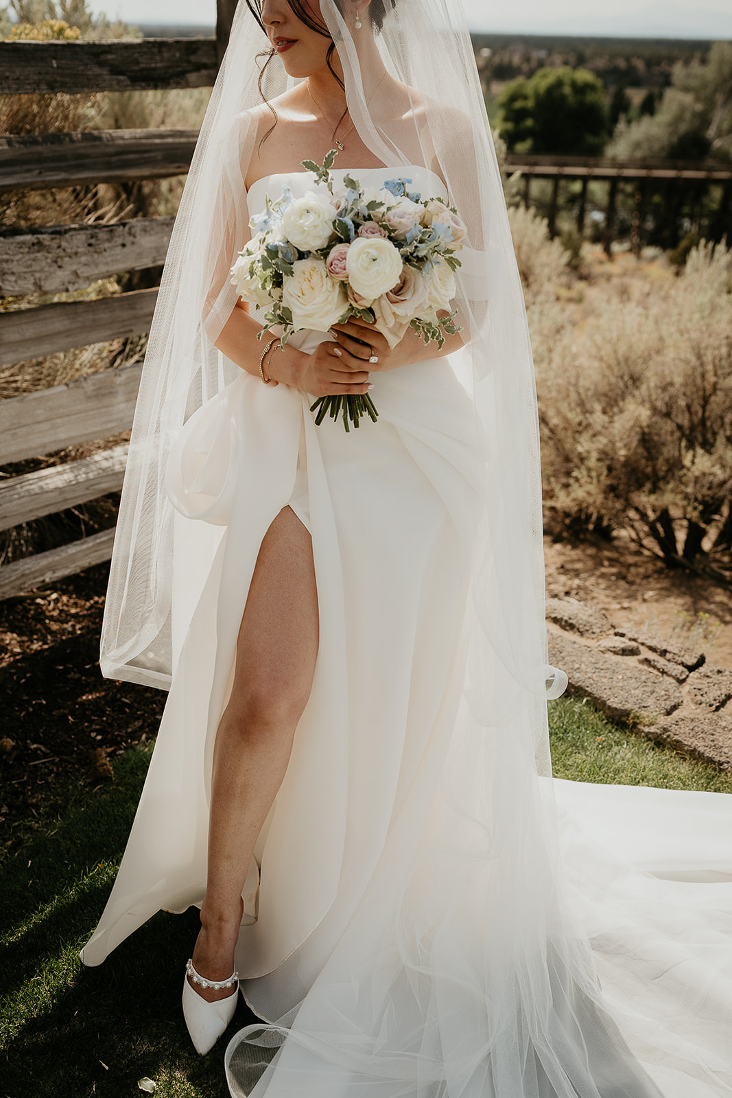 the bride in her dress showing off her leg during her Brasada Ranch wedding.