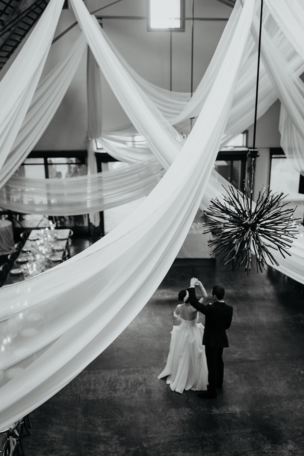 the newlyweds dancing in their reception space, the Barn, during their Brasada Ranch wedding.