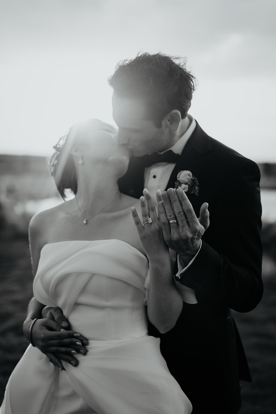 newlyweds kissing showing off their wedding rings during their Brasada Ranch wedding.