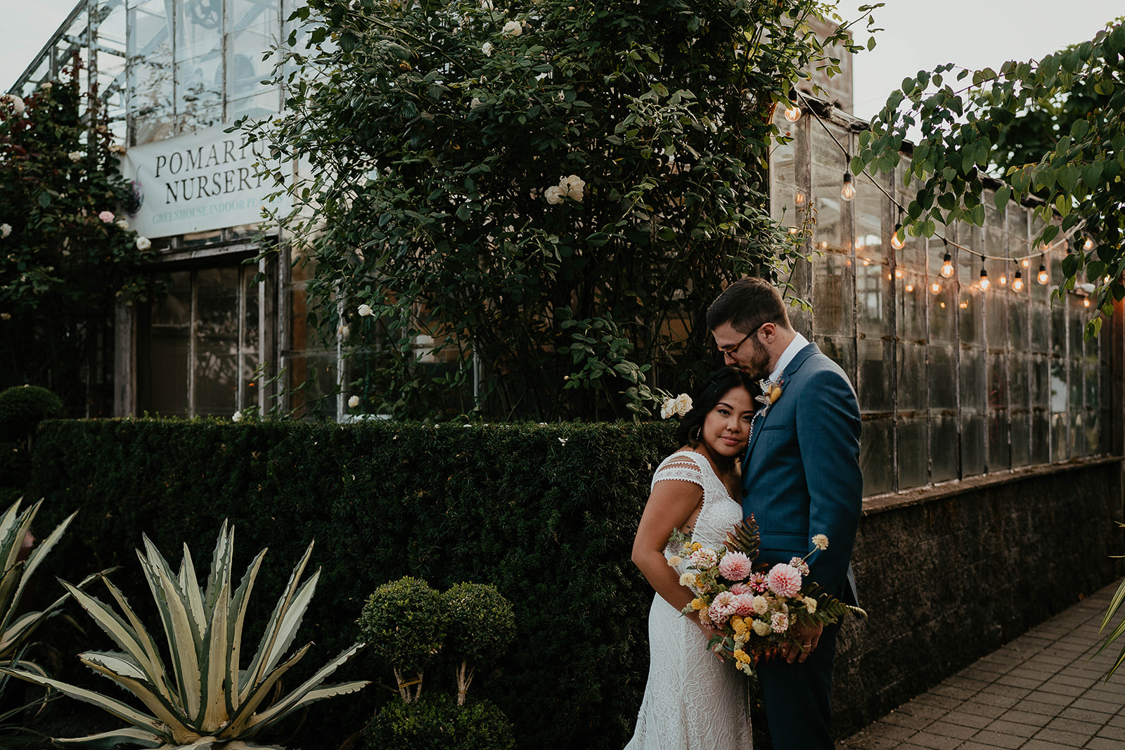 newlyweds hugging in front of Blockhouse wedding venue.