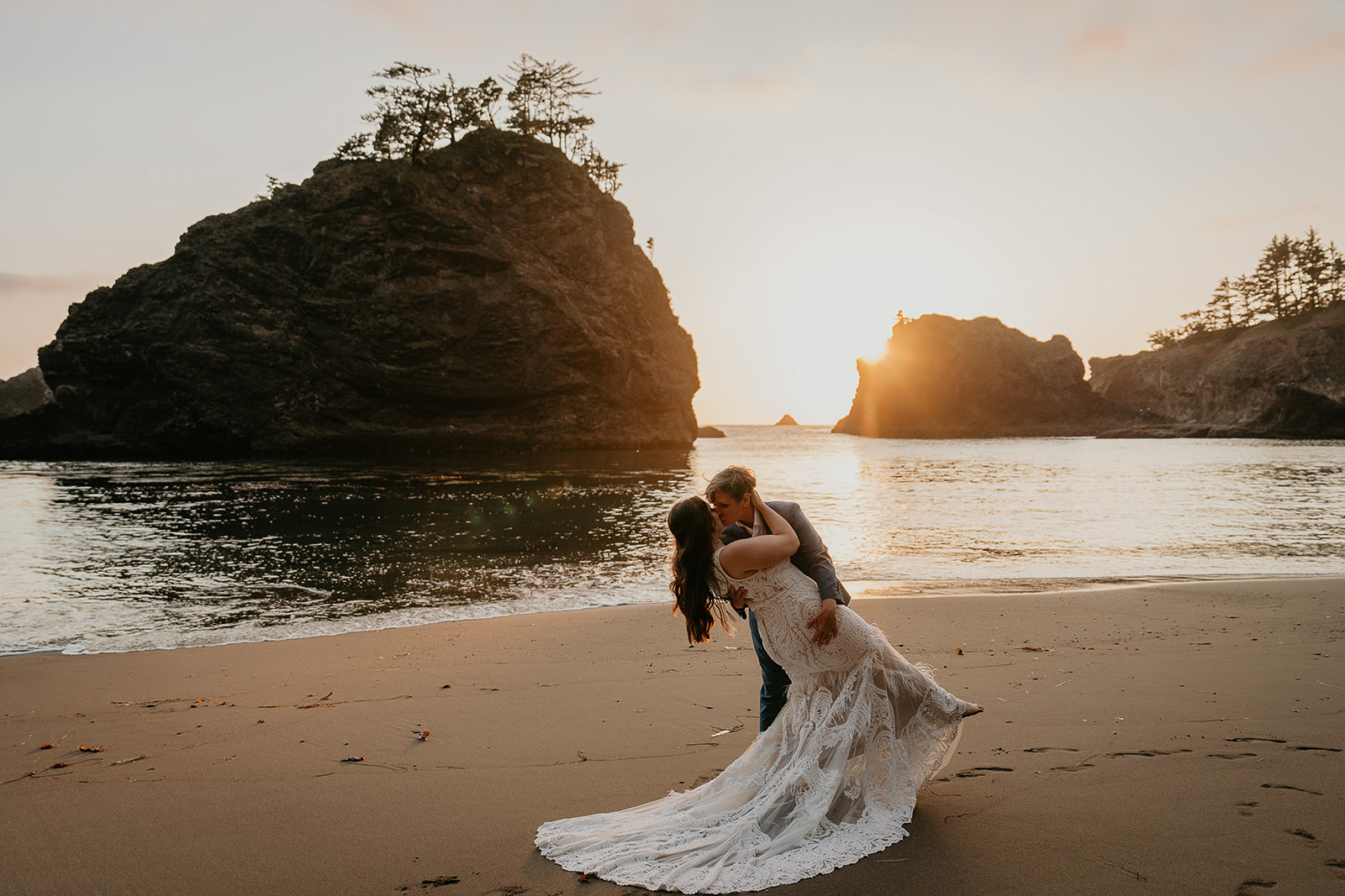 newlyweds kissing on the Oregon Coast at sunset. 