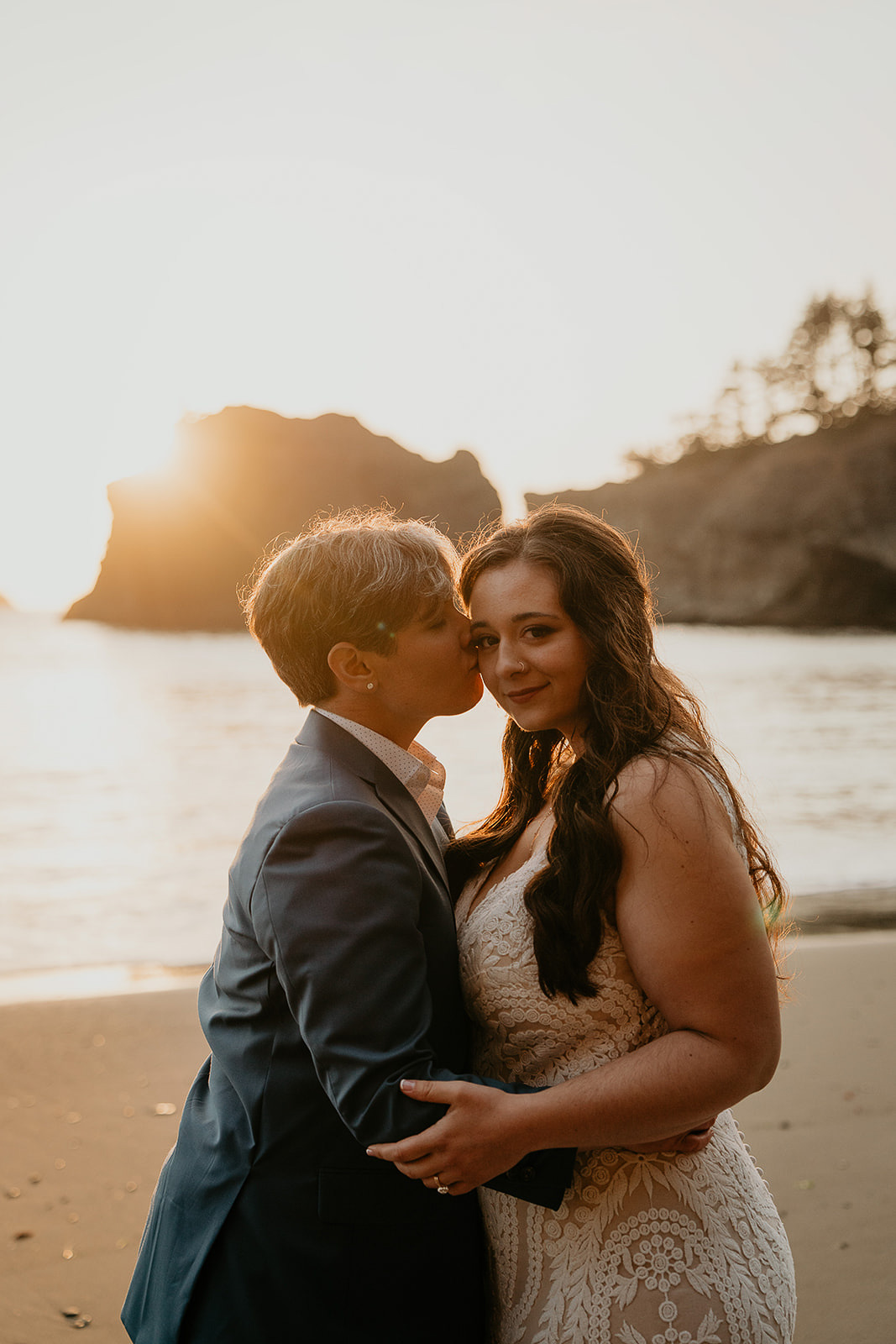 newlyweds kissing on the beach on the Southern Oregon Coast, outside one of the many beautiful wedding venues. 