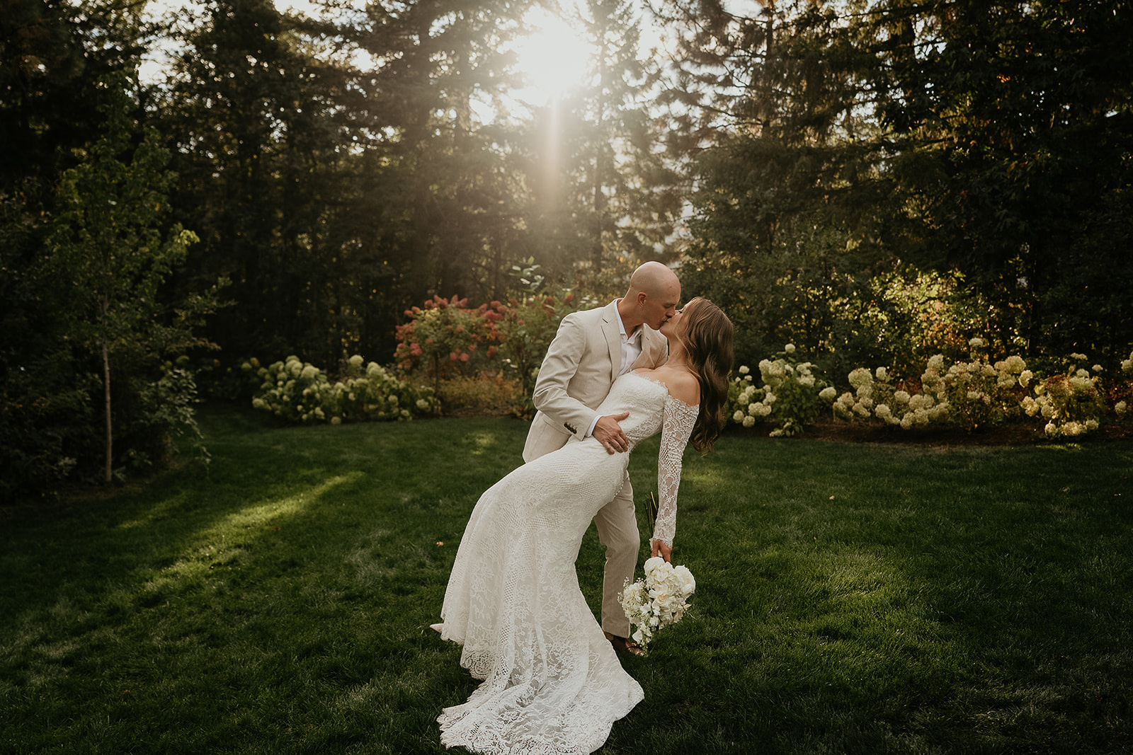 newlyweds kissing at sunset during their Rocky Hill Oregon wedding.