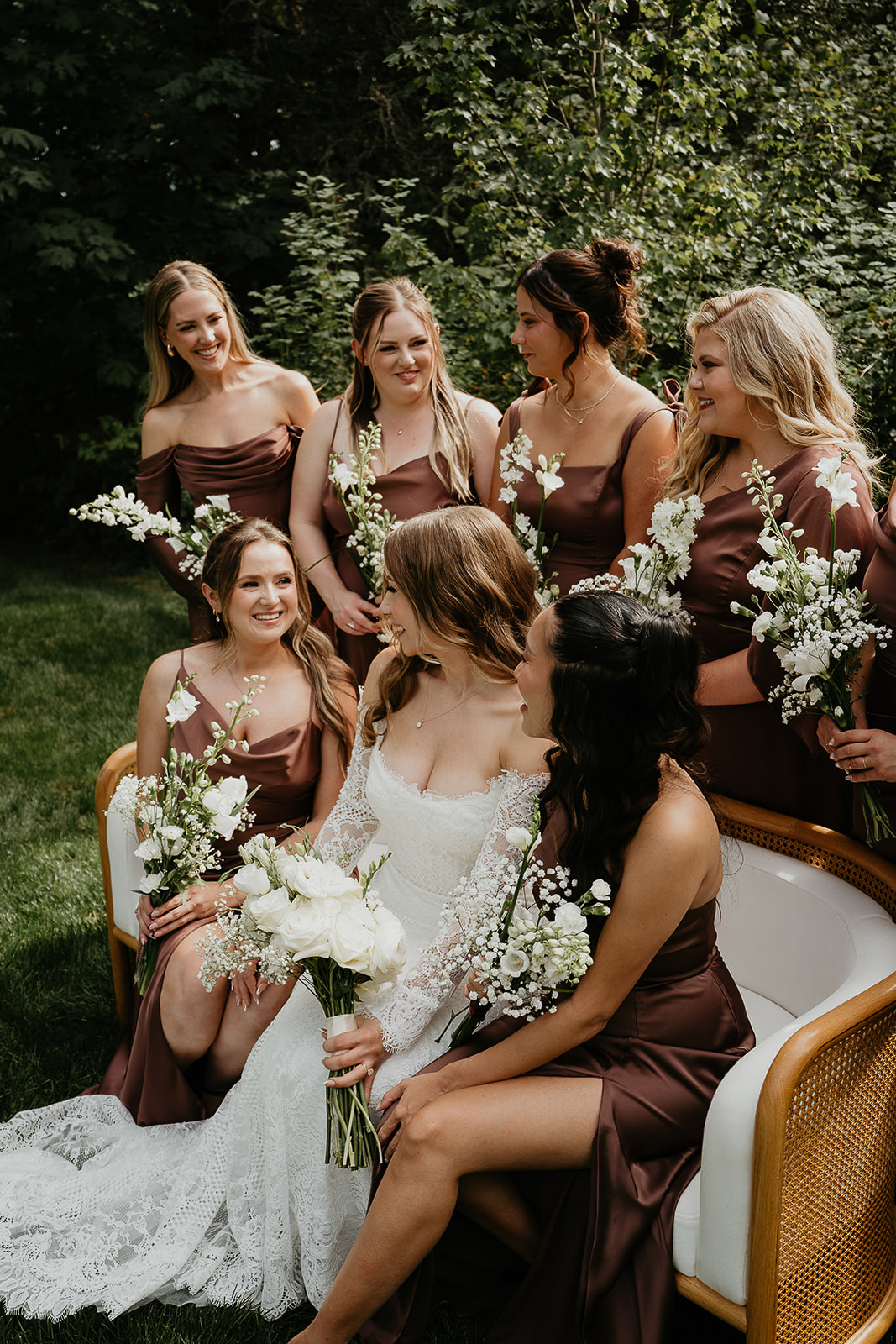 the bride on a bench with her bridesmaids during their Rocky Hill Oregon wedding.