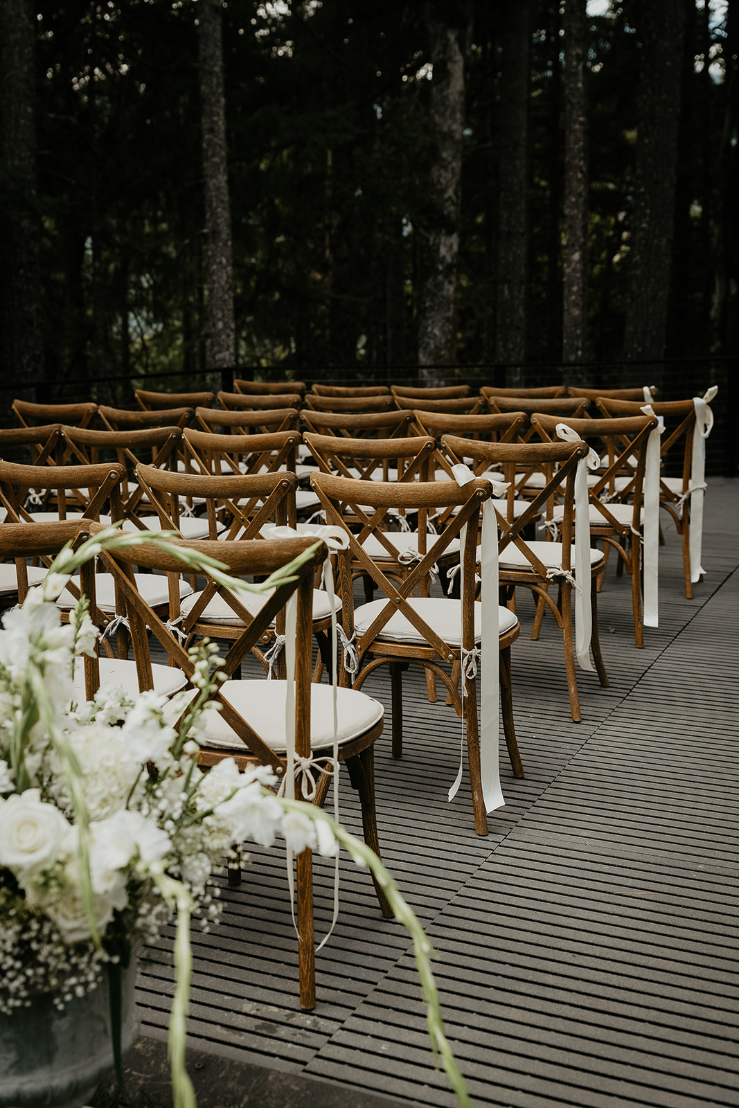 a bouquet of flowers and chairs set up on the Rocky Hill Oregon wedding deck