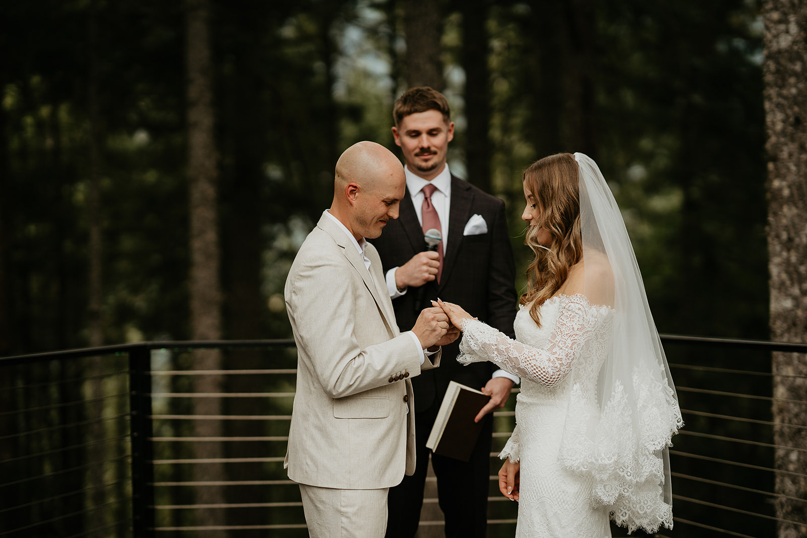 the groom putting on the bride's ring during their Rocky Hill Oregon wedding ceremony.