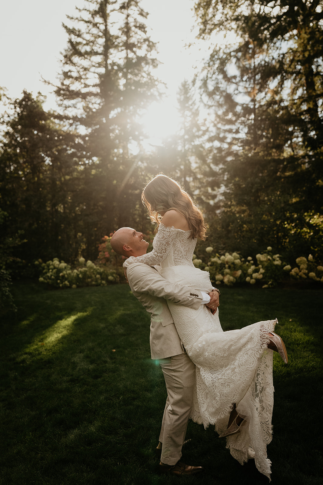 the bride and groom hugging at sunset during their Rocky Hill Oregon wedding.
