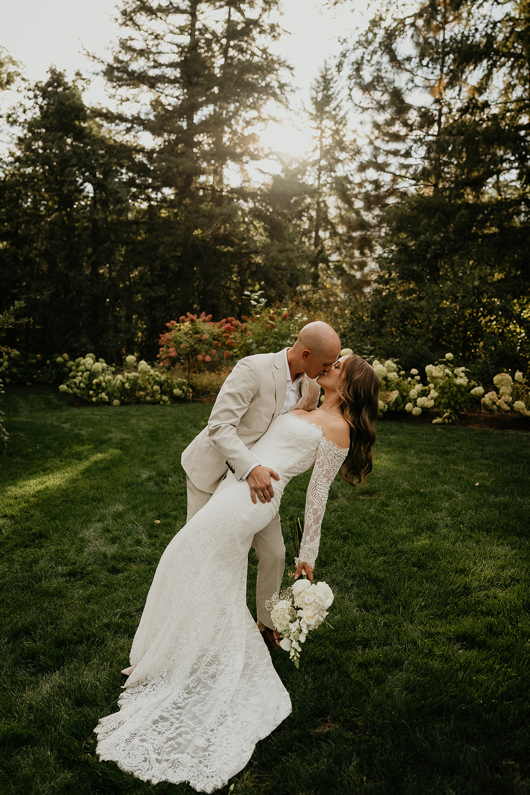 the newlyweds kissing at sunset during their Rocky Hill Oregon wedding.