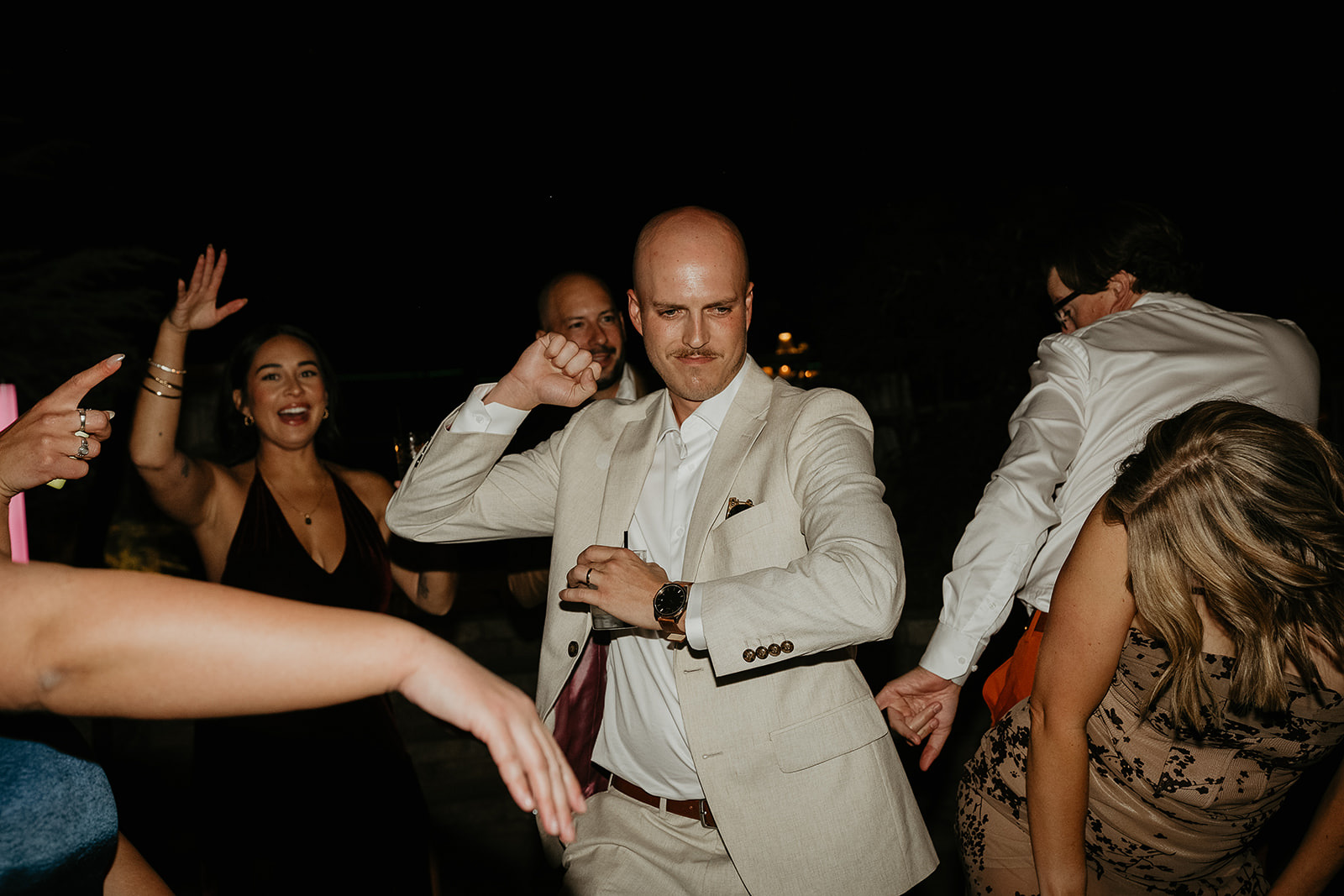 the groom dancing with his wedding guests.