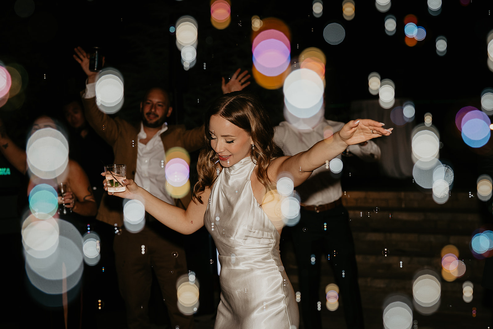 the bride dancing during her Rocky Hill Oregon wedding surrounded by bubbles.