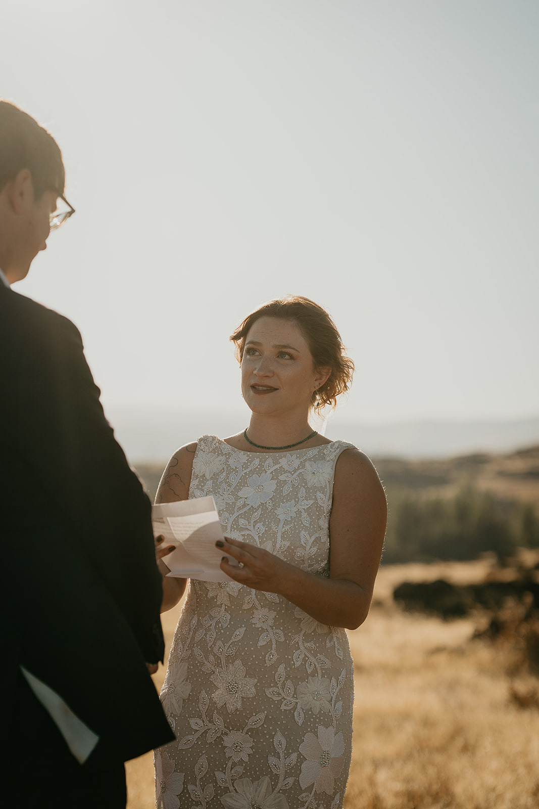 bride reading a poem to her husband during their Columbia River Gorge elopement.