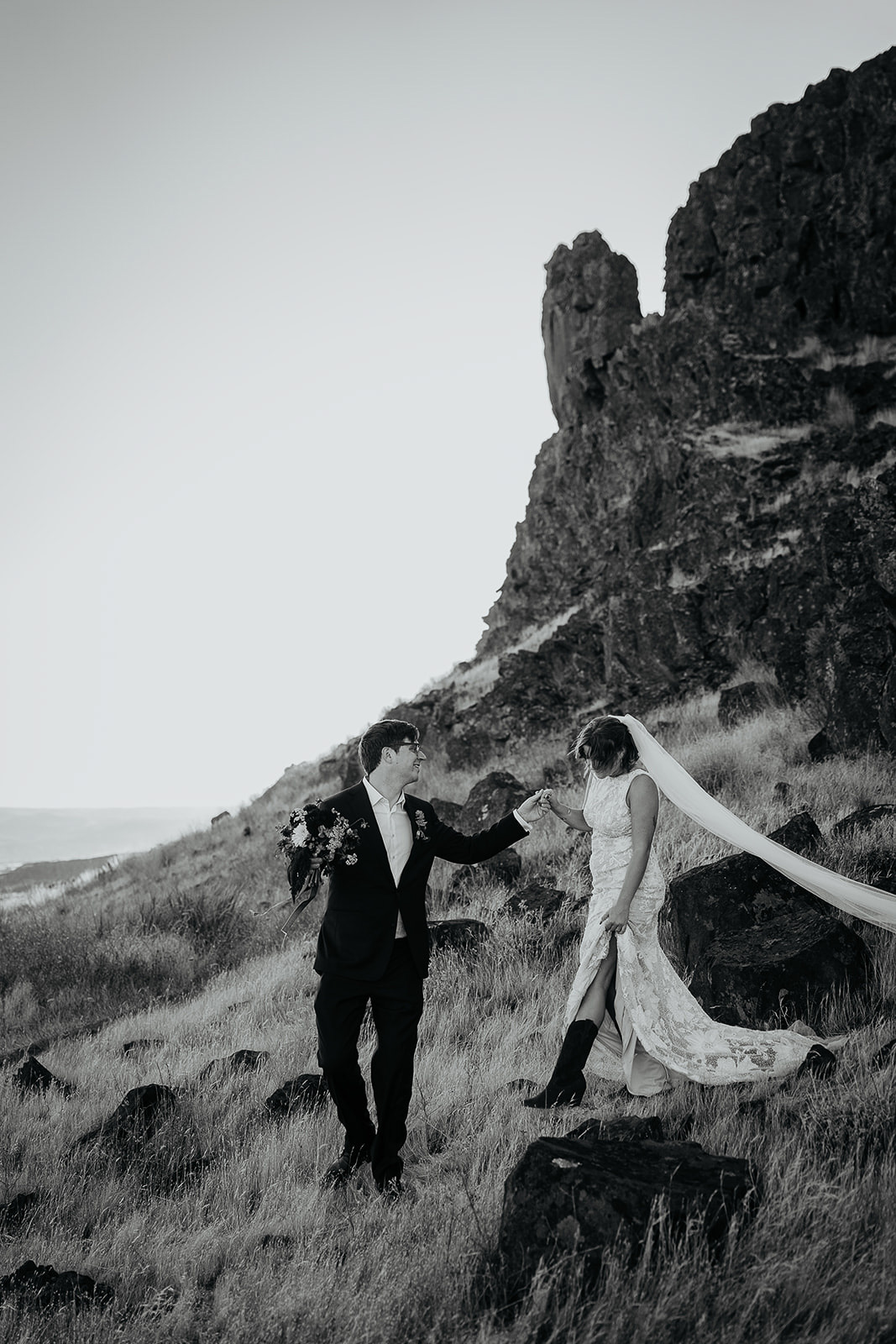 newlyweds walking down a hill during their Columbia River Gorge elopement.