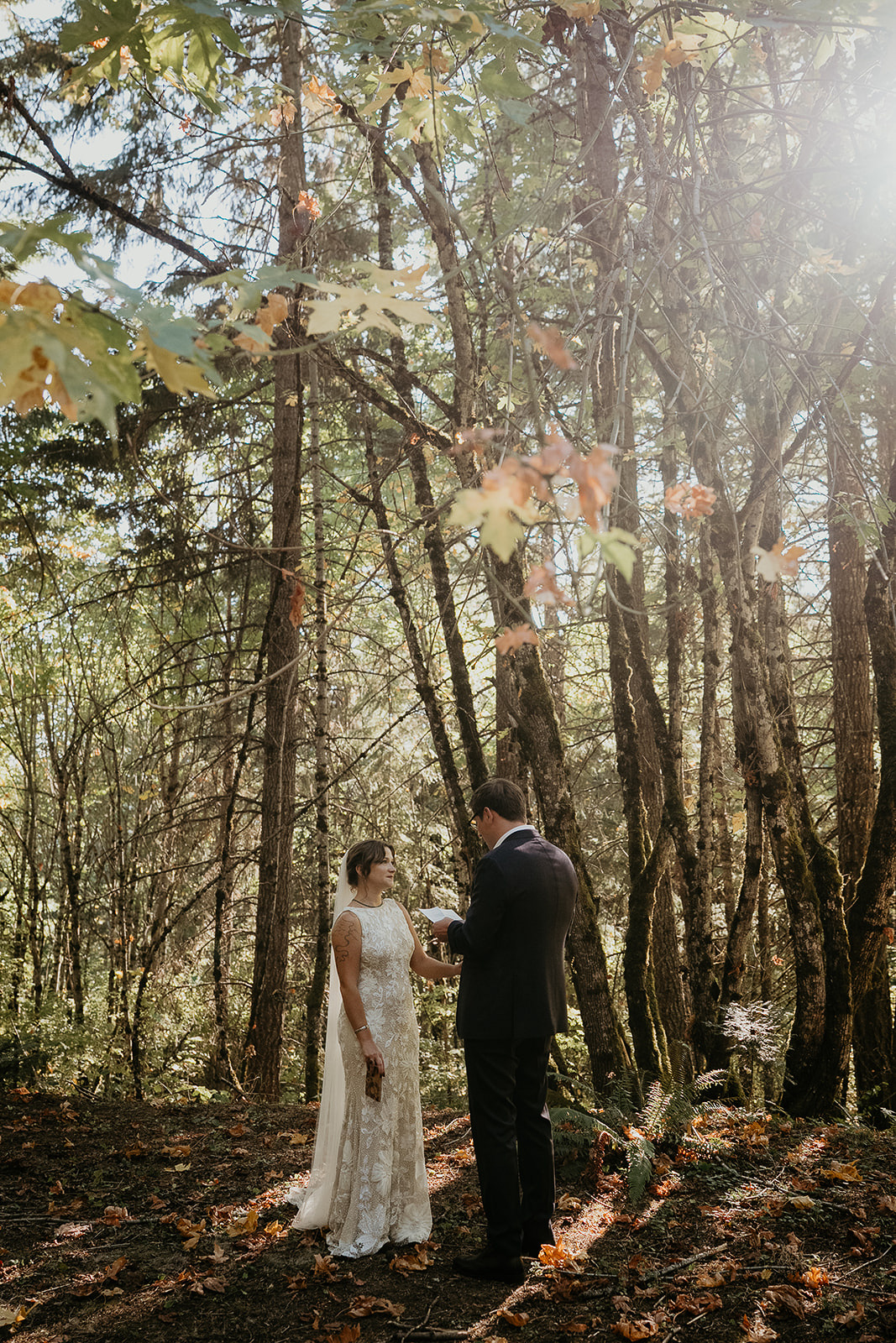 newlyweds reading letters in a forest during their Columbia River Gorge elopement.
