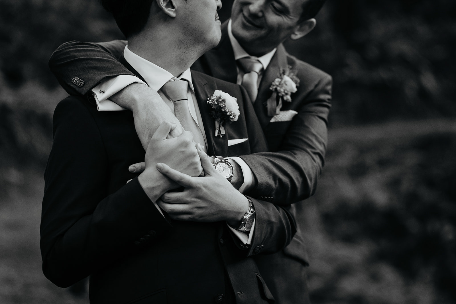 newlyweds hugging and holding hands.