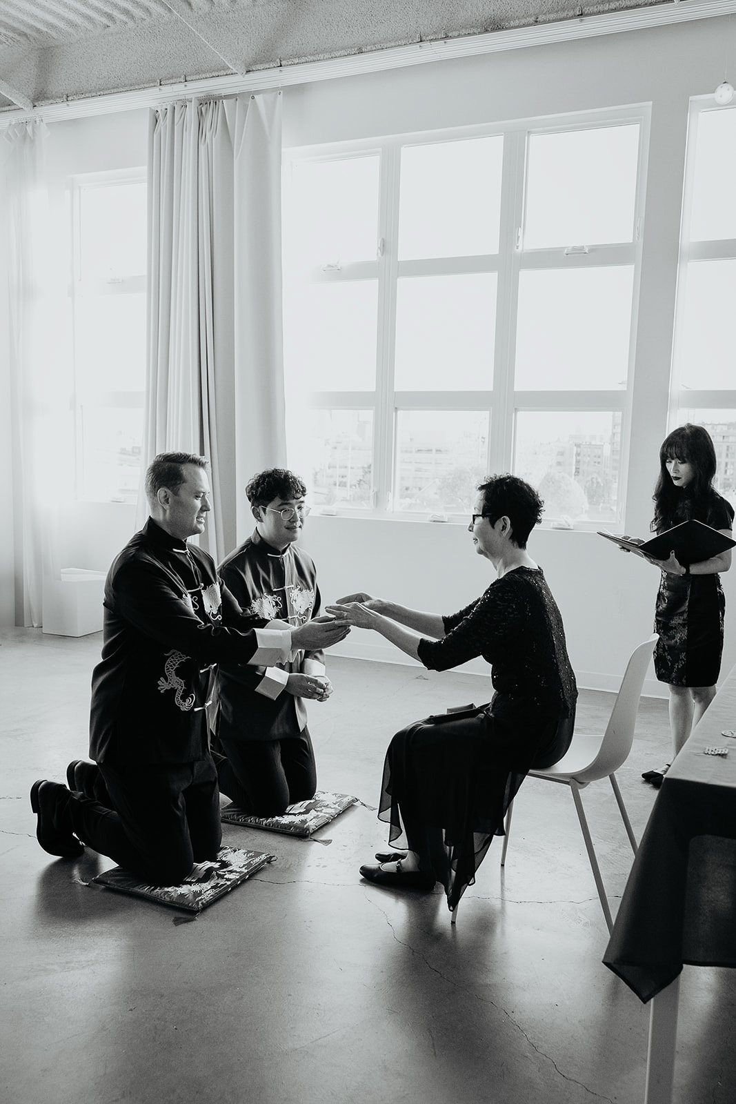 newlyweds performing a traditional chinese tea ceremony.