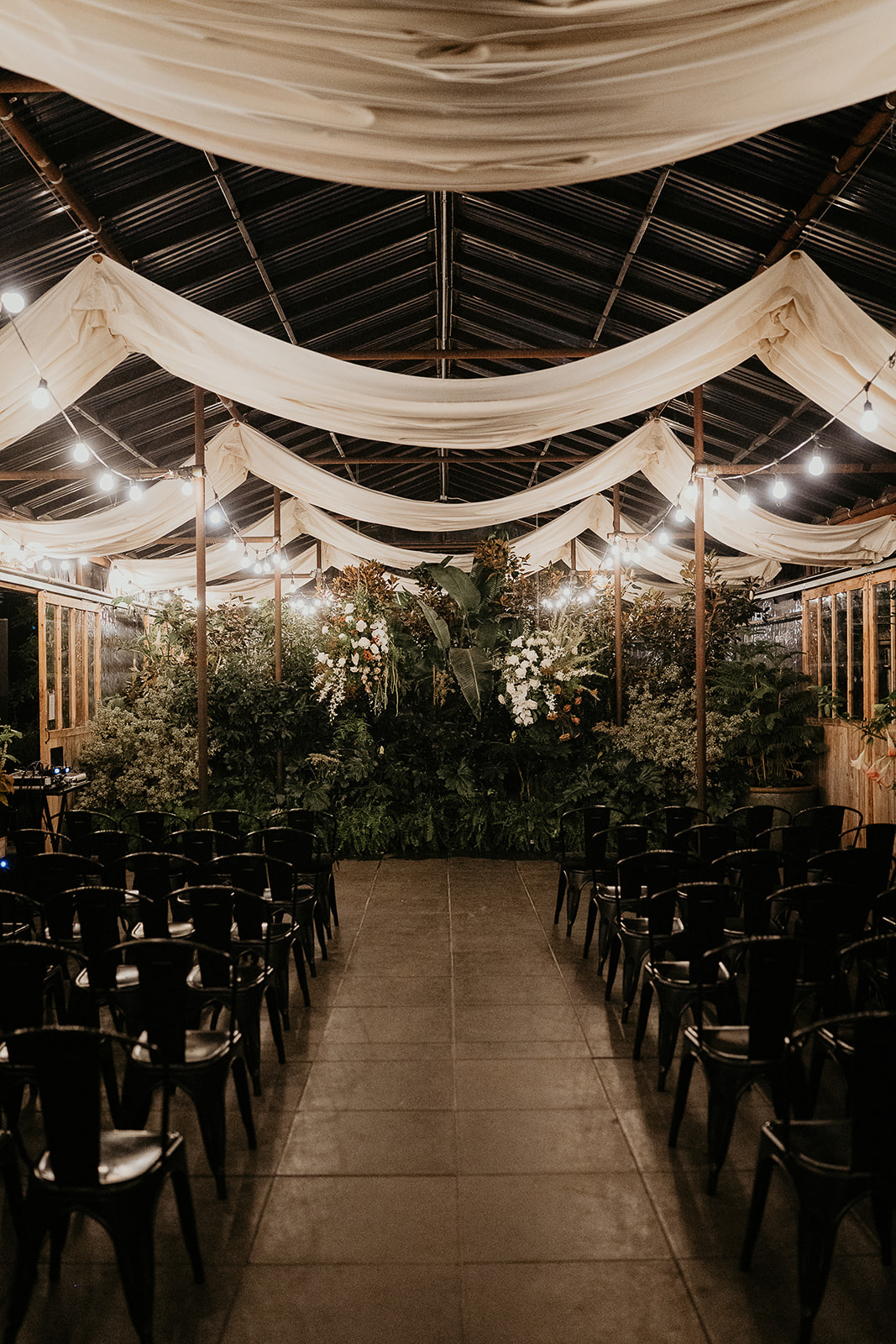 a wedding ceremony location inside a greenhouse.