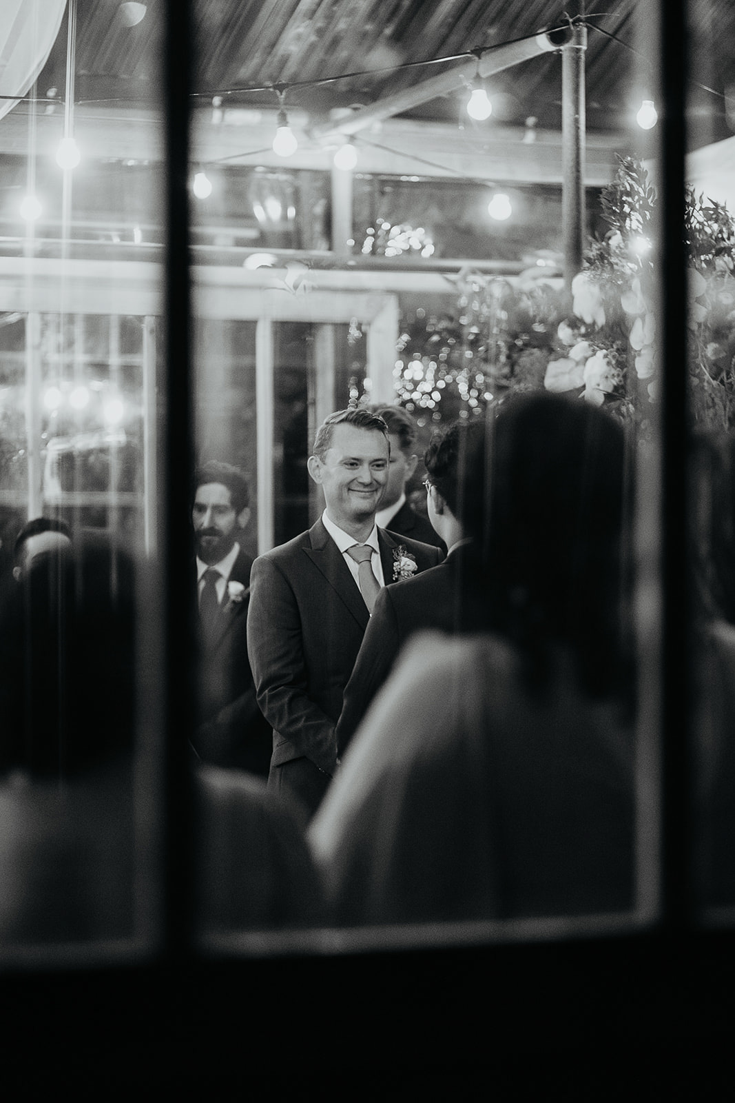 one of the grooms smiling during his wedding ceremony.