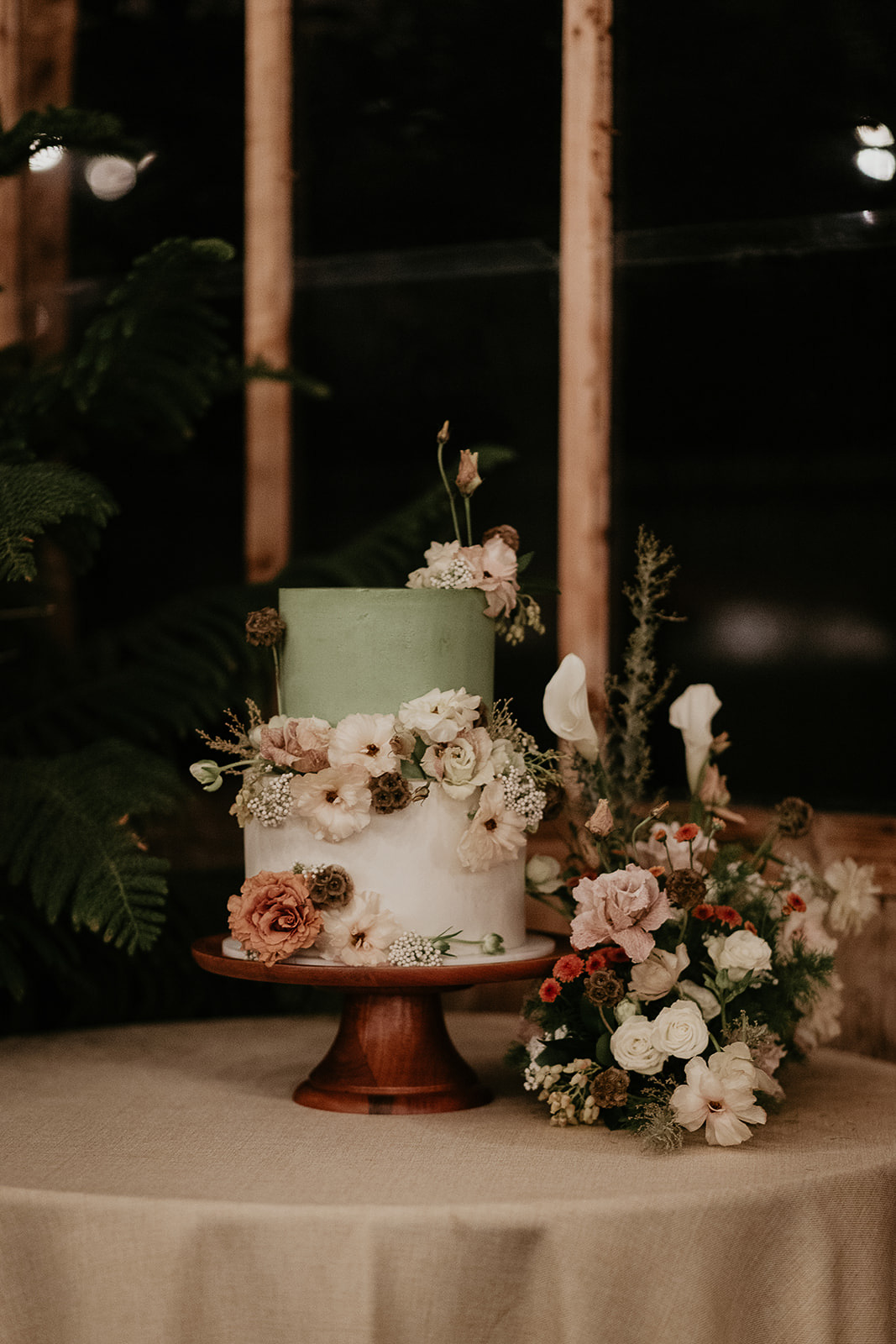 two story wedding cake during their forest elopement in Oregon.