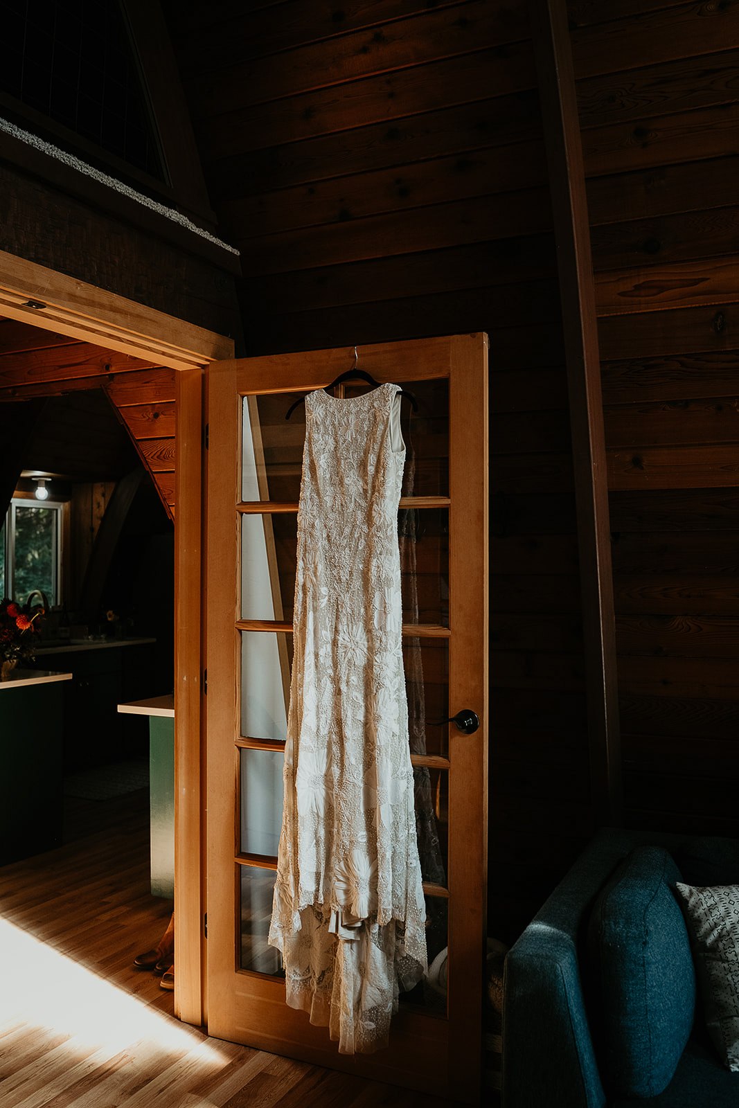 a wedding dress hanging from a door.