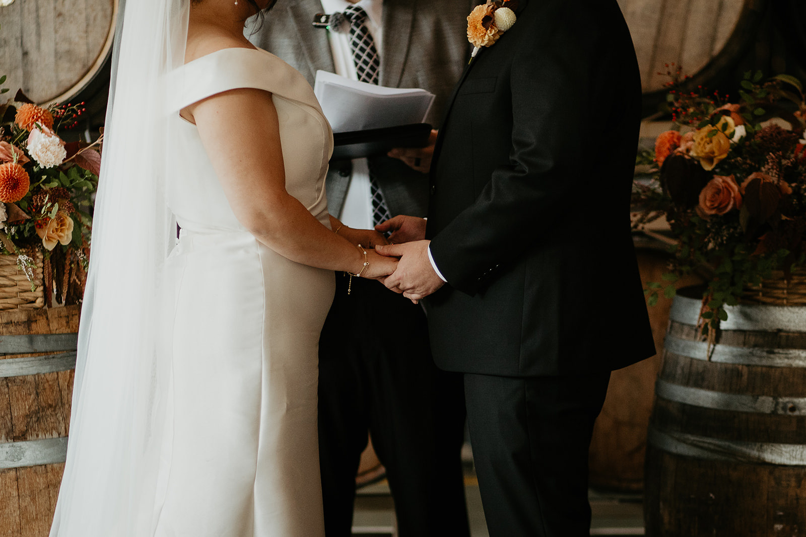 Newlyweds holding hands during their Coopers Hall wedding.