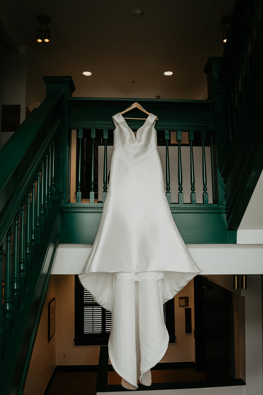 wedding dress hanging from a staircase.