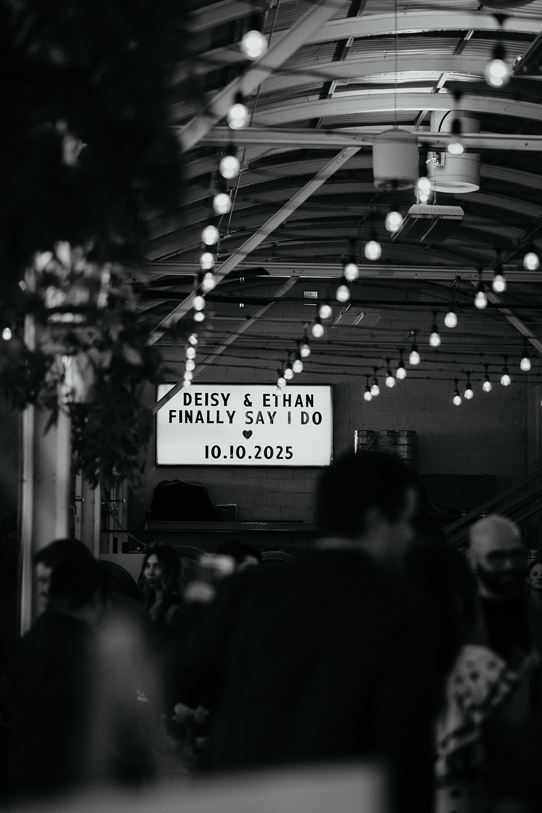 a sign that reads "Deisy & Ethan Finally Say I Do 10.10.2025"