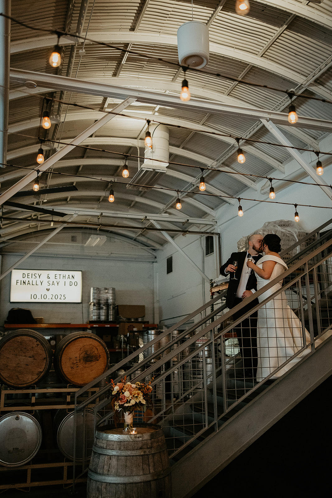 newlyweds kissing walking down stairs.