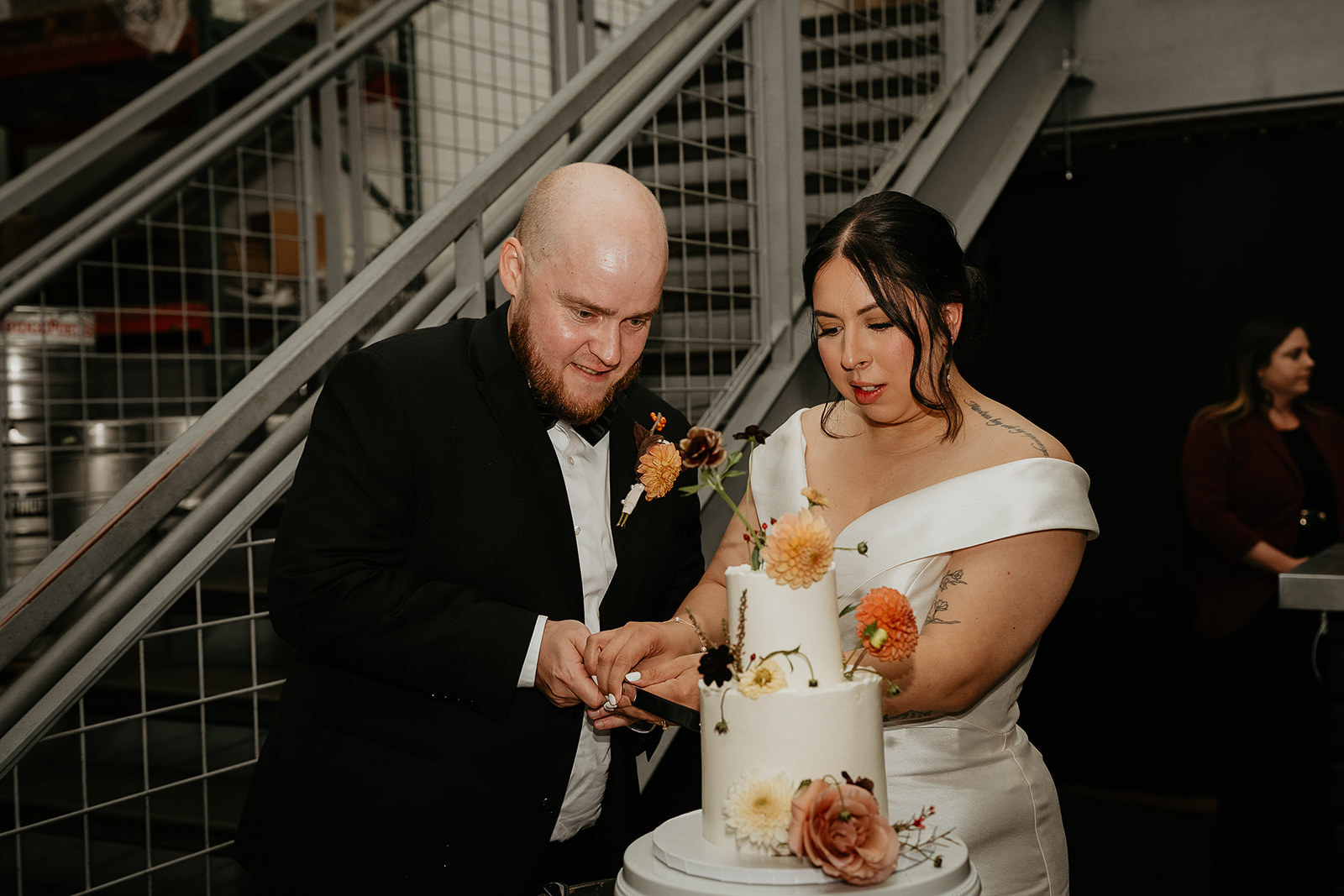 newlyweds cutting cake during their Coopers Hall wedding.