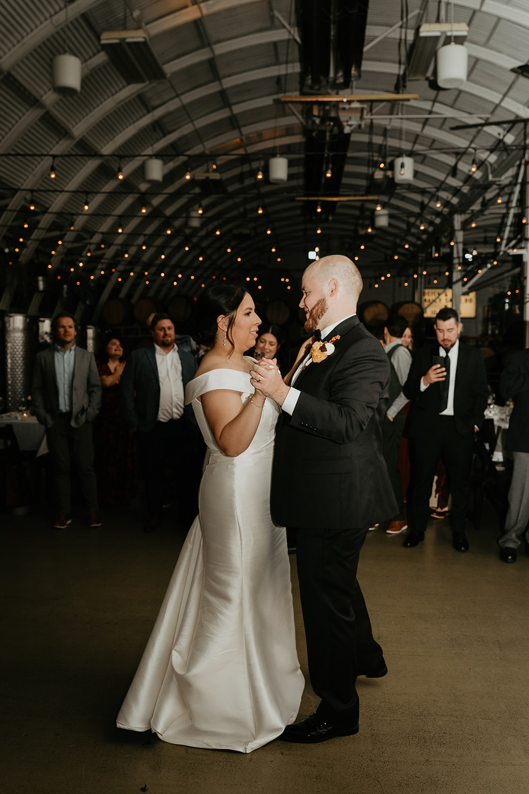 newlywed dancing under bistro lights during their Coopers Hall wedding.